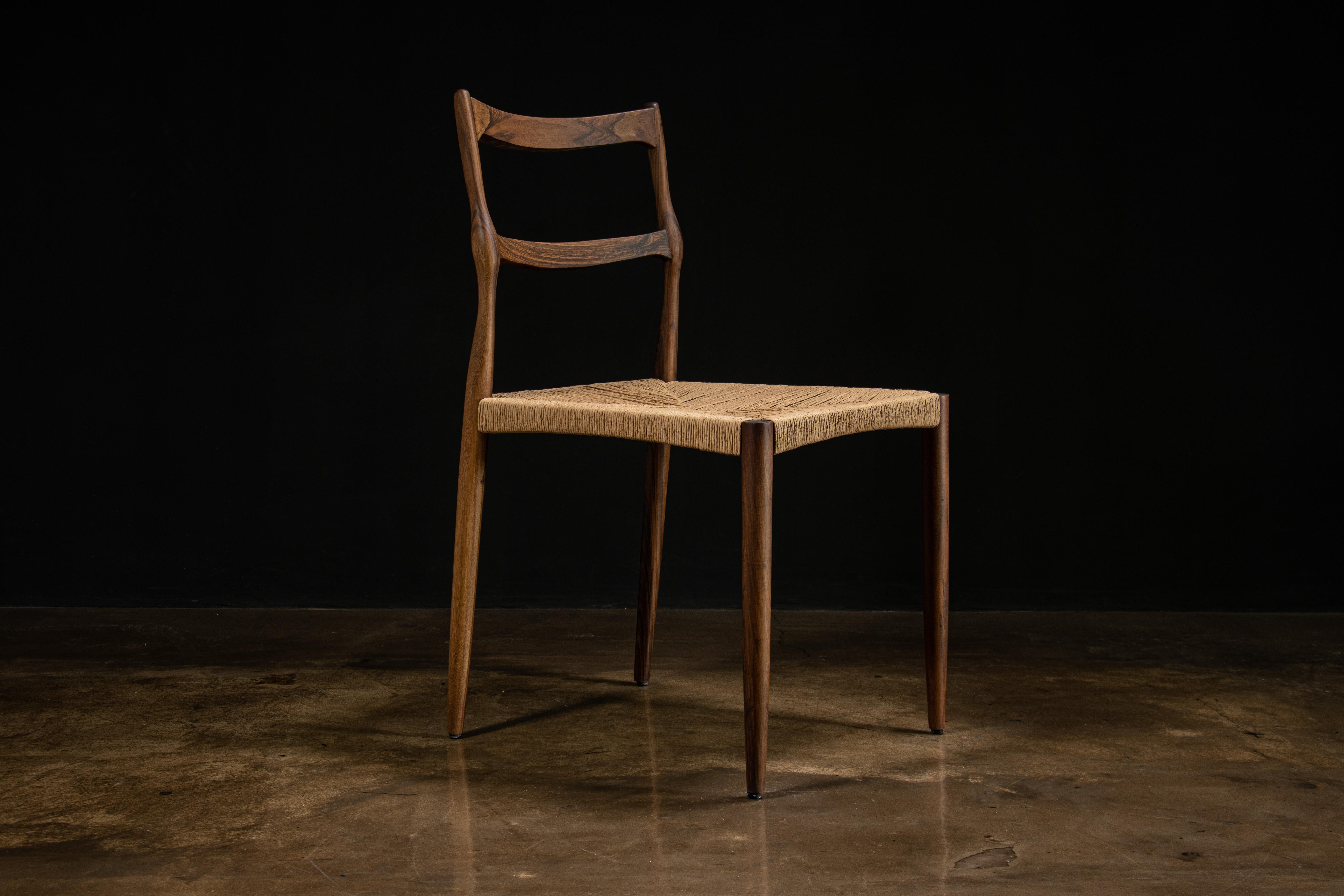 Our homage to Gio Ponti’s Superleggera chair features a thin hand-carved frame and hand woven rush seat.

Shown in Argentine Rosewood with carefully selected planks to maximize landscaping across the carved details on the back leg. Available as