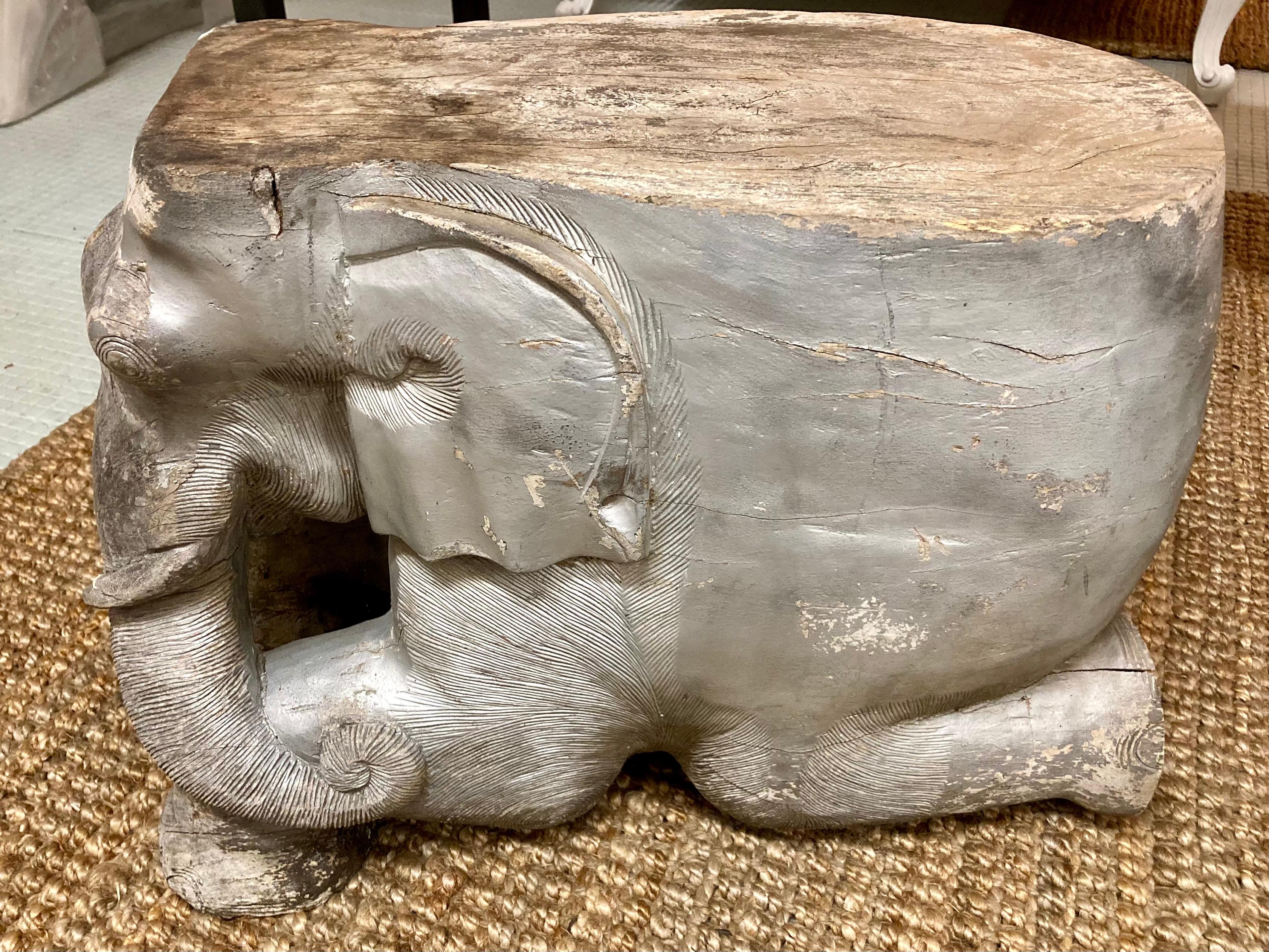 Beautiful carved wood elephant cocktail table/seat. This elephant shows trunk swinging to the right side, and we have two available in stock. Additionally, we have another pair with trunk swinging to the left so collect them all! They have an aged