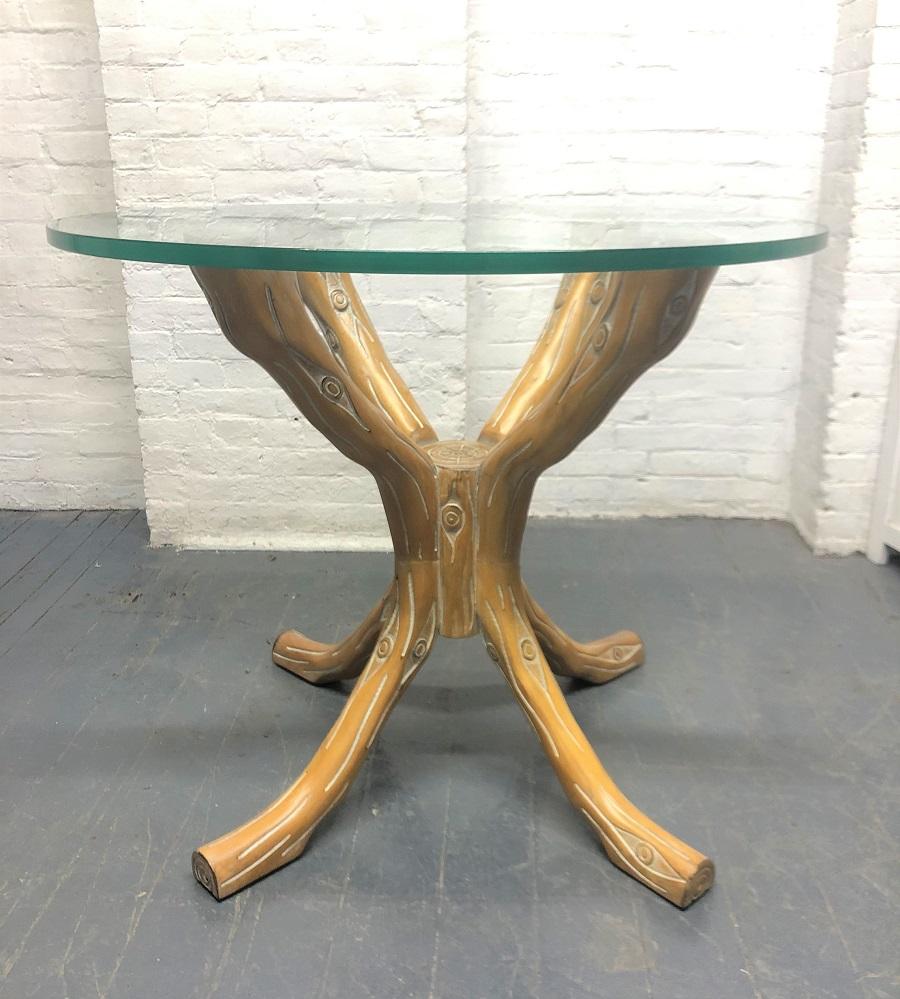Carved wood faux bois table. The base is similar to tree branches with a cerused finish. The table has a round glass top and can be used as a center or dining table. The base can accommodate a larger piece of glass.