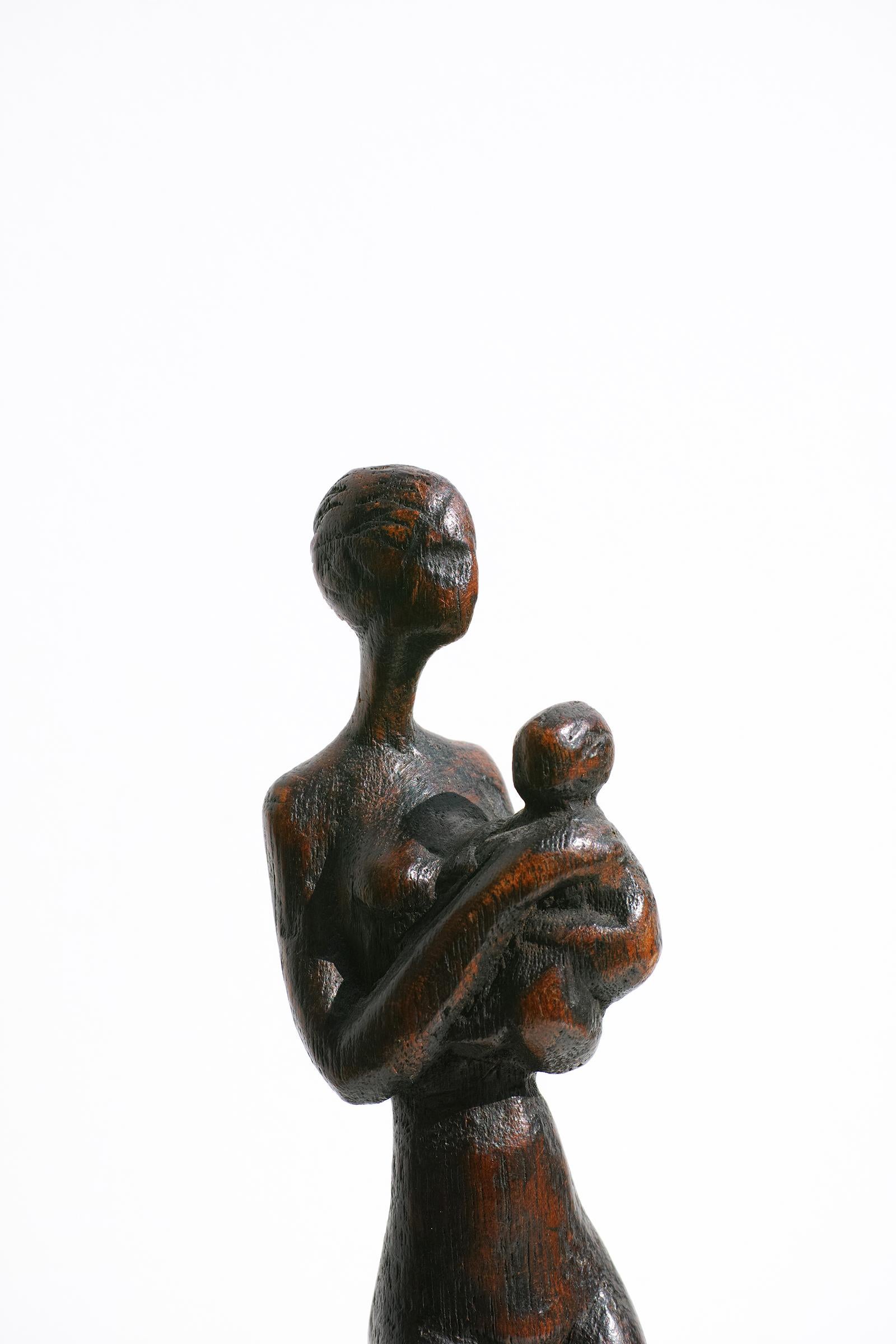 For your consideration is this elegantly slender figural sculpture of a woman with child by Danish artist, Otto Pedersen. Pedersen hand-carved this sculpture from a single piece of wood. The sculpture has its original dark finish, carved 