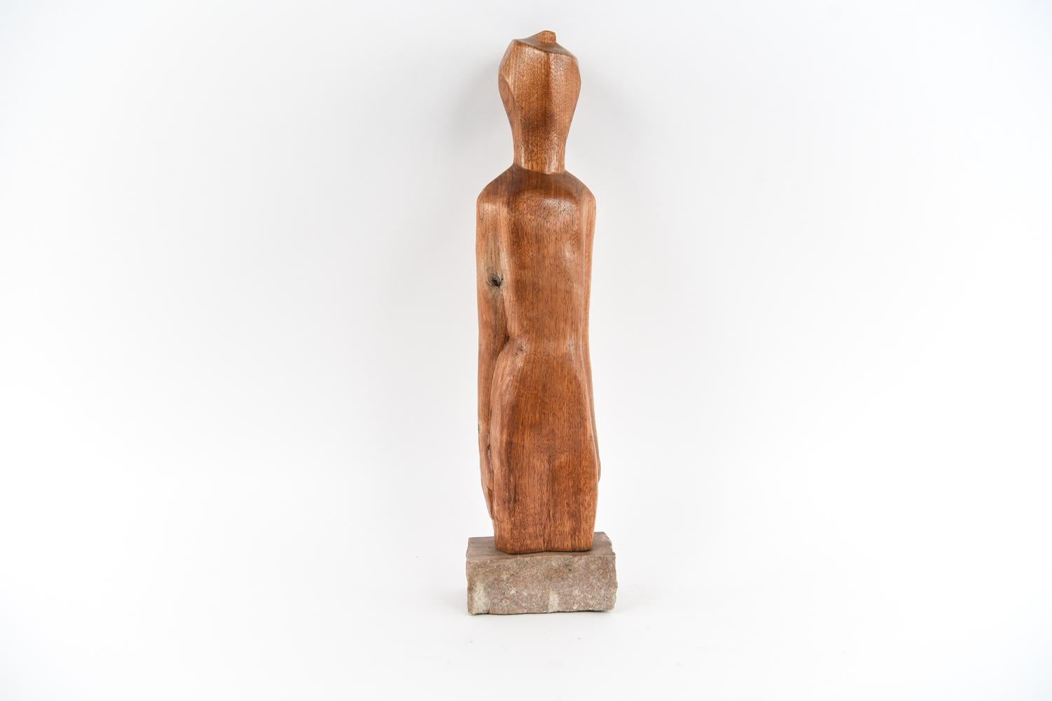 Elaine Kaufman Feiner, American (b. 1922).
Carved wood sculpture on stone base, circa 1960s. Apparently unsigned.
The poignant simplicity in this figurative tabletop sculpture evokes a palpable feeling of hope. A New York City native, Kaufman
