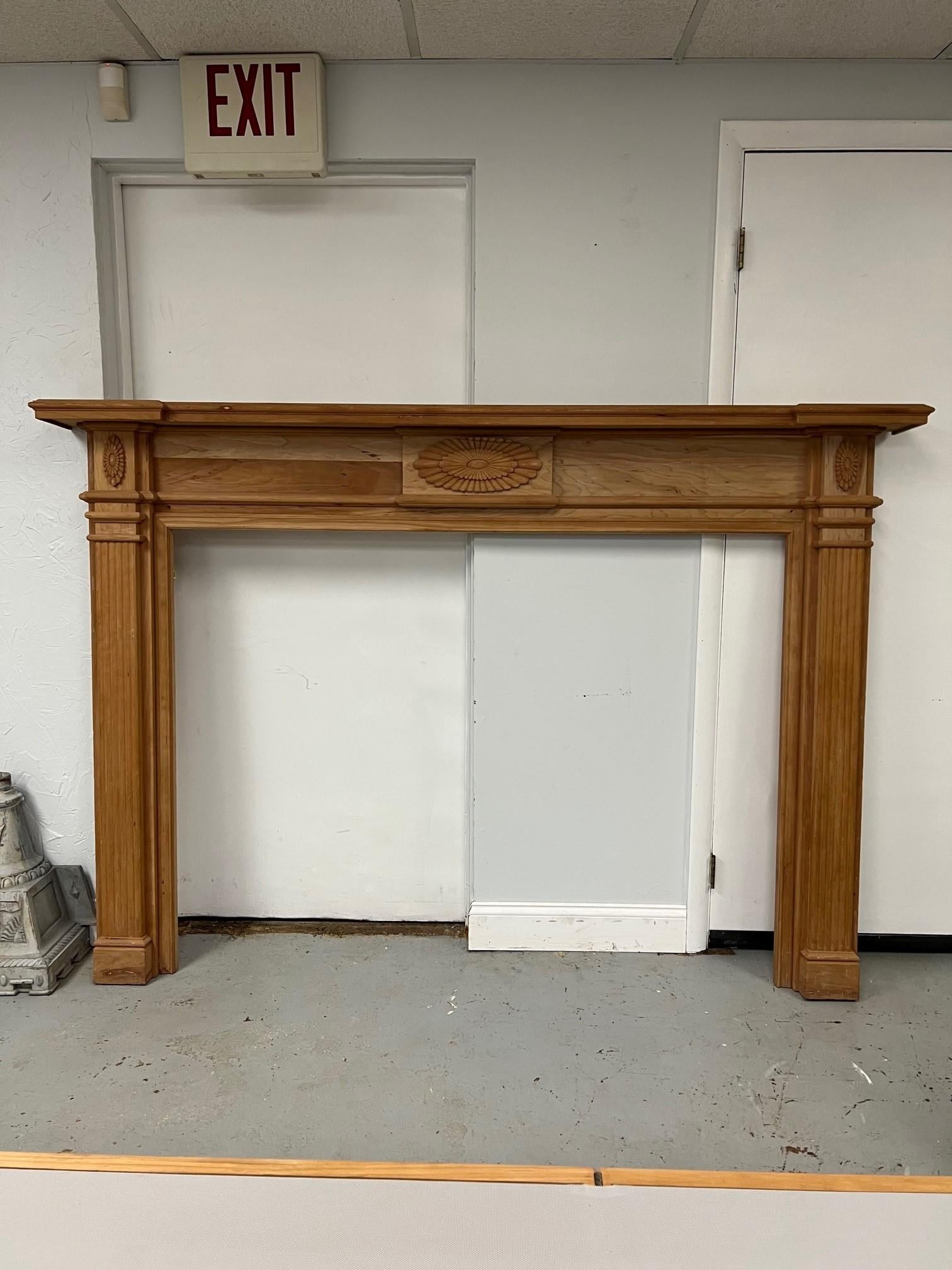 Very nice and simple solid cherry wood fireplace mantel with fluted legs and carved wood center. This was from a Brooklyn NY manufacture who closed. The mantel has never been installed and is a nice solid cherry which would look beautiful stained or