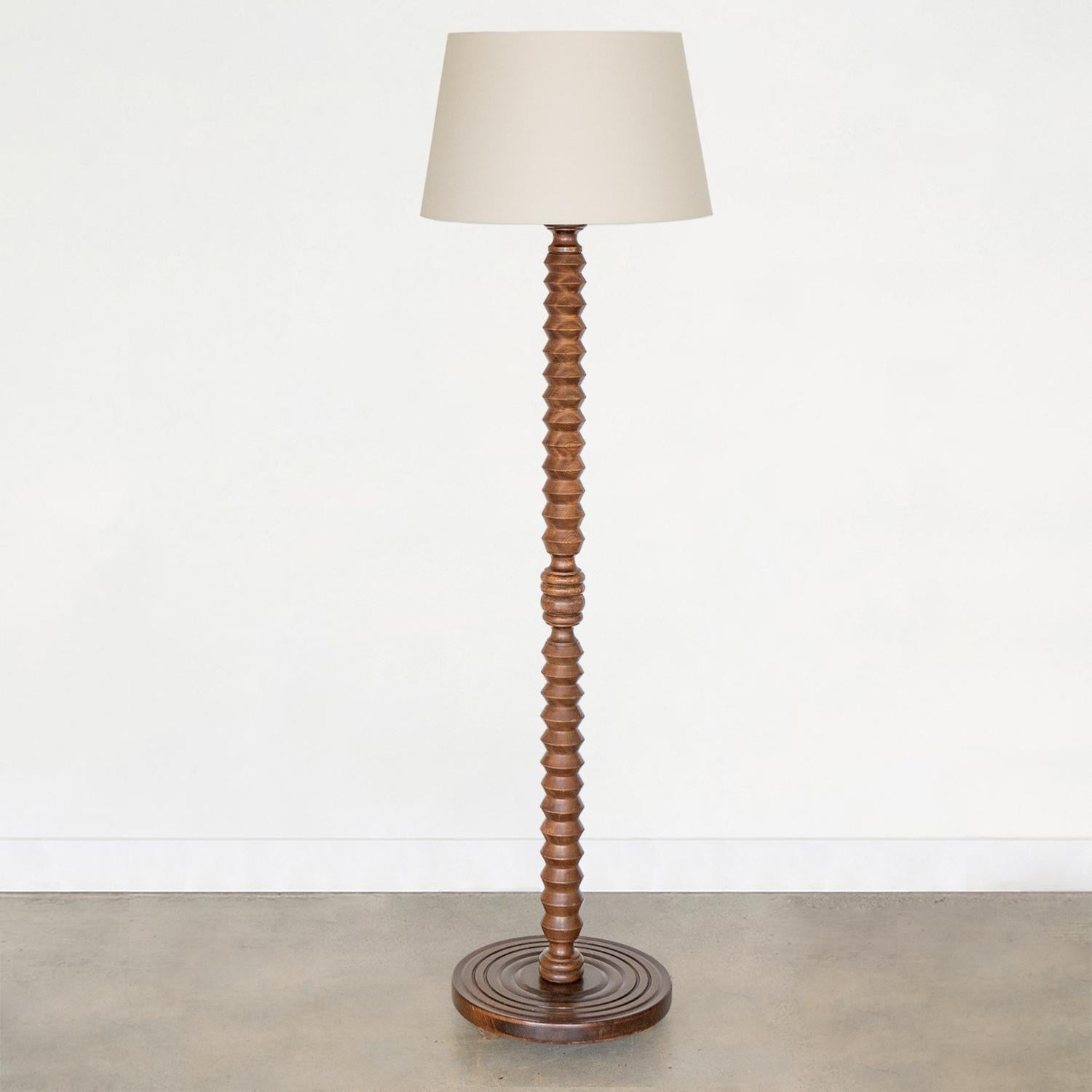 Lovely carved wood floor lamp by Charles Dudouyt from France, 1940s. Great carved design on stem with dark stain on wood. Newly re-wired and new linen shade. Great vintage condition.