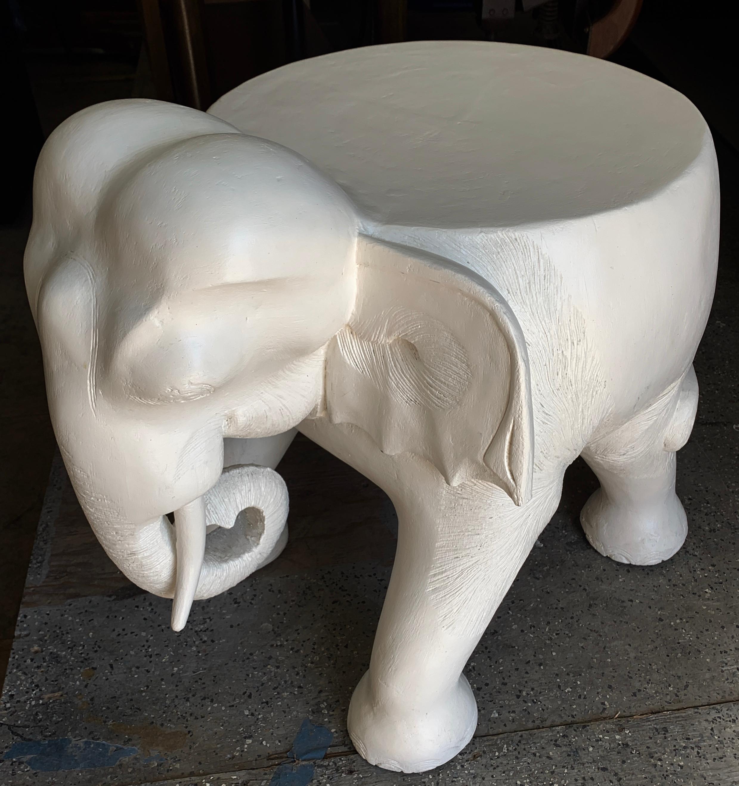 Carved elephant is a solid block of wood, finished in a lacquer / gesso finish, and is reminiscent of a John Dickinson piece. Artfully carved and very heavy - the piece is. compliment to many environments, from modern to traditional... also a nice