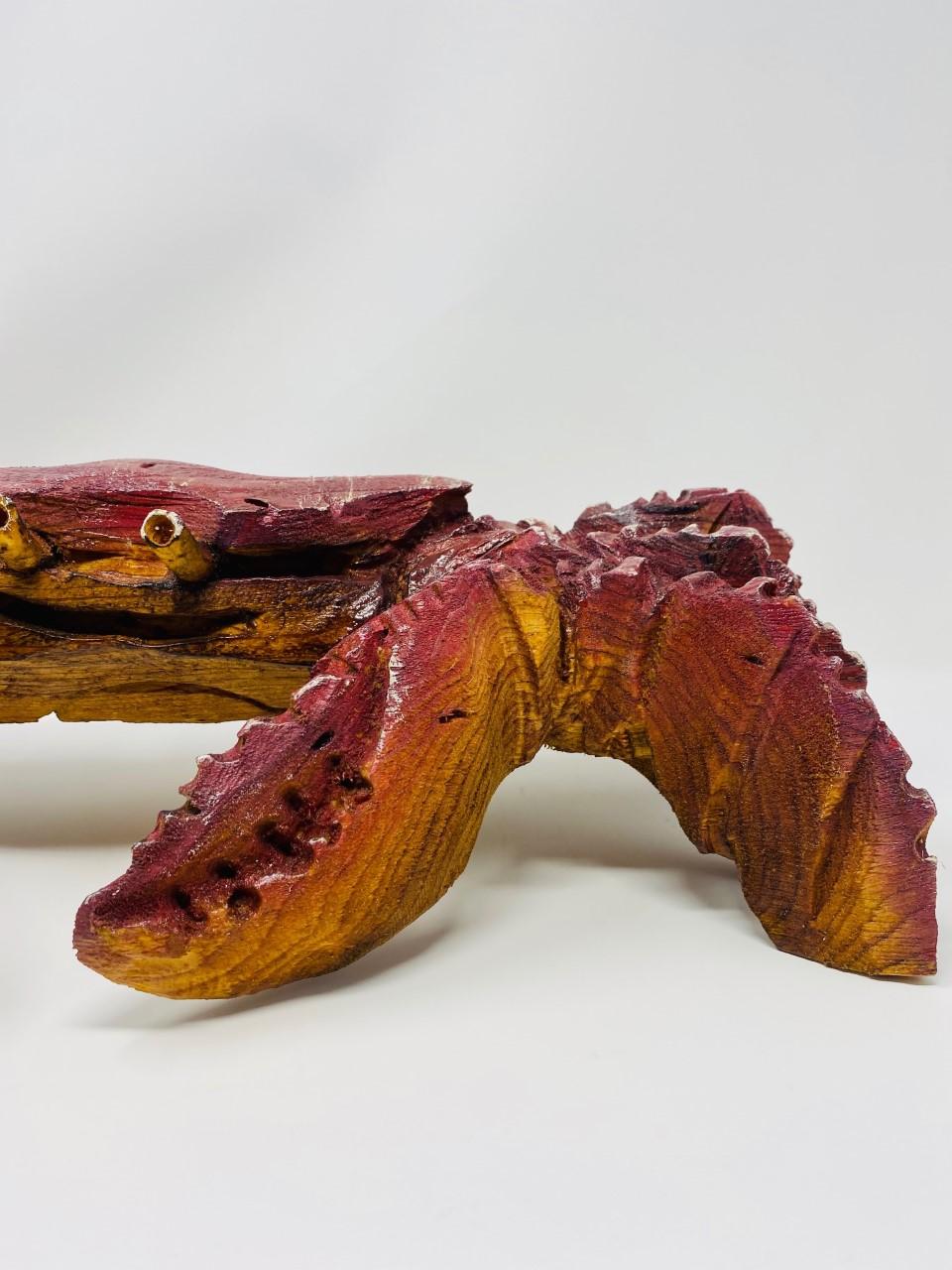 Beautiful rendered, carved wood giant crab sculpture. This piece is both striking and beautiful. Almost lifelike, a single piece of wood has been meticulously carved to resemble this sea creature. The sculpted carving along with the wood texture