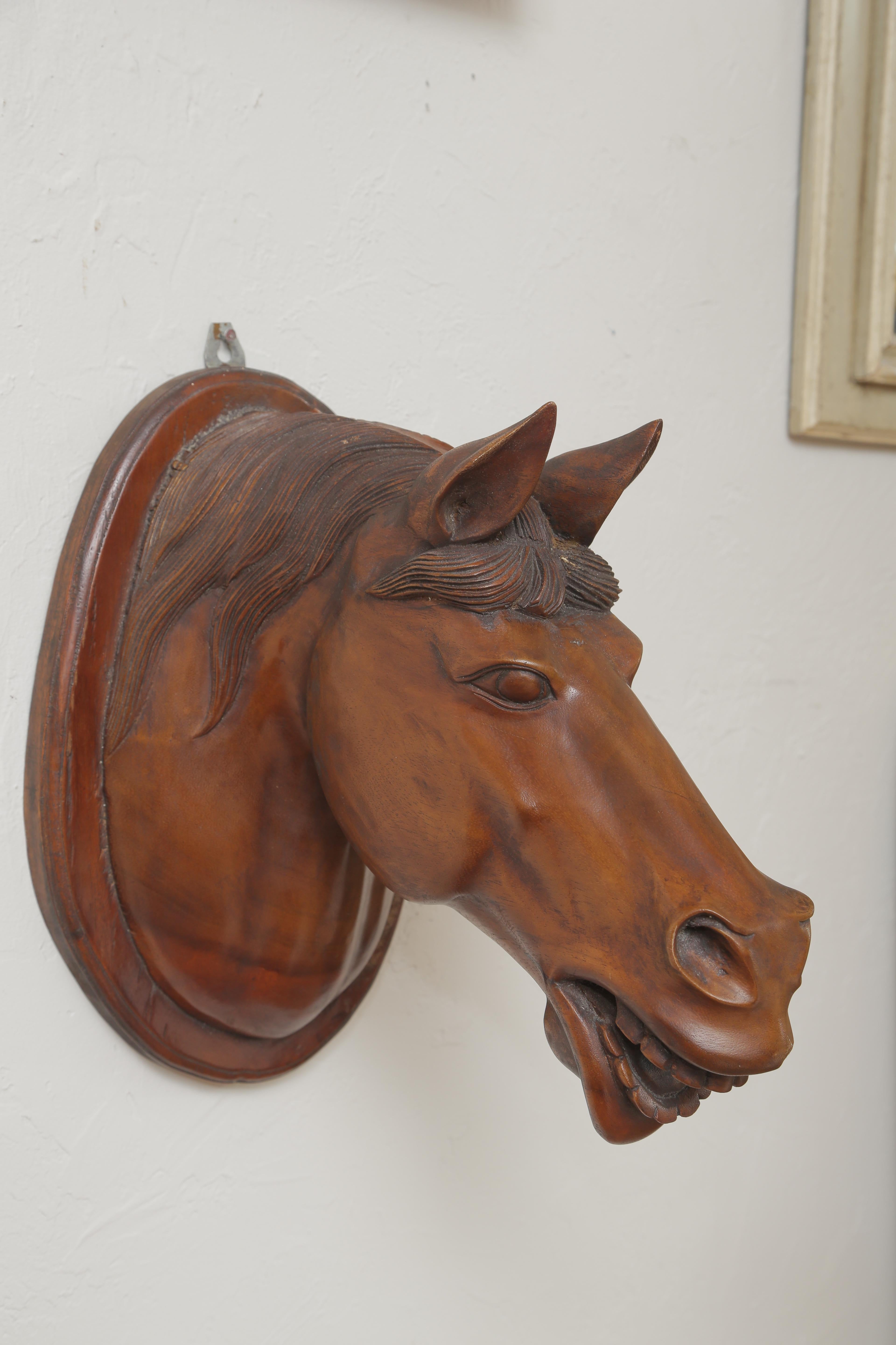 Hand carved sculpture of a horse head.
