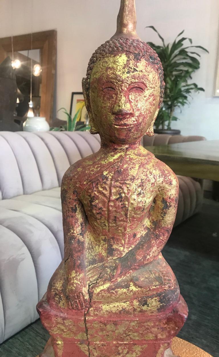Carved from a single block of wood and deeply colored and decorated. Buddha has a pleasant facial expression. Likely from Laos or Northern Thai. We are listing as 20th century but could be older.

Dimensions: 22