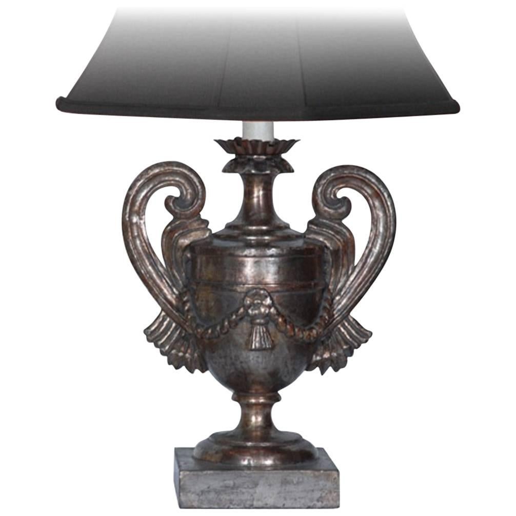 Pair of carved wooden lamp base featuring a vase and handle design with an antique silver finish, Italy.
** Shades not included. **.