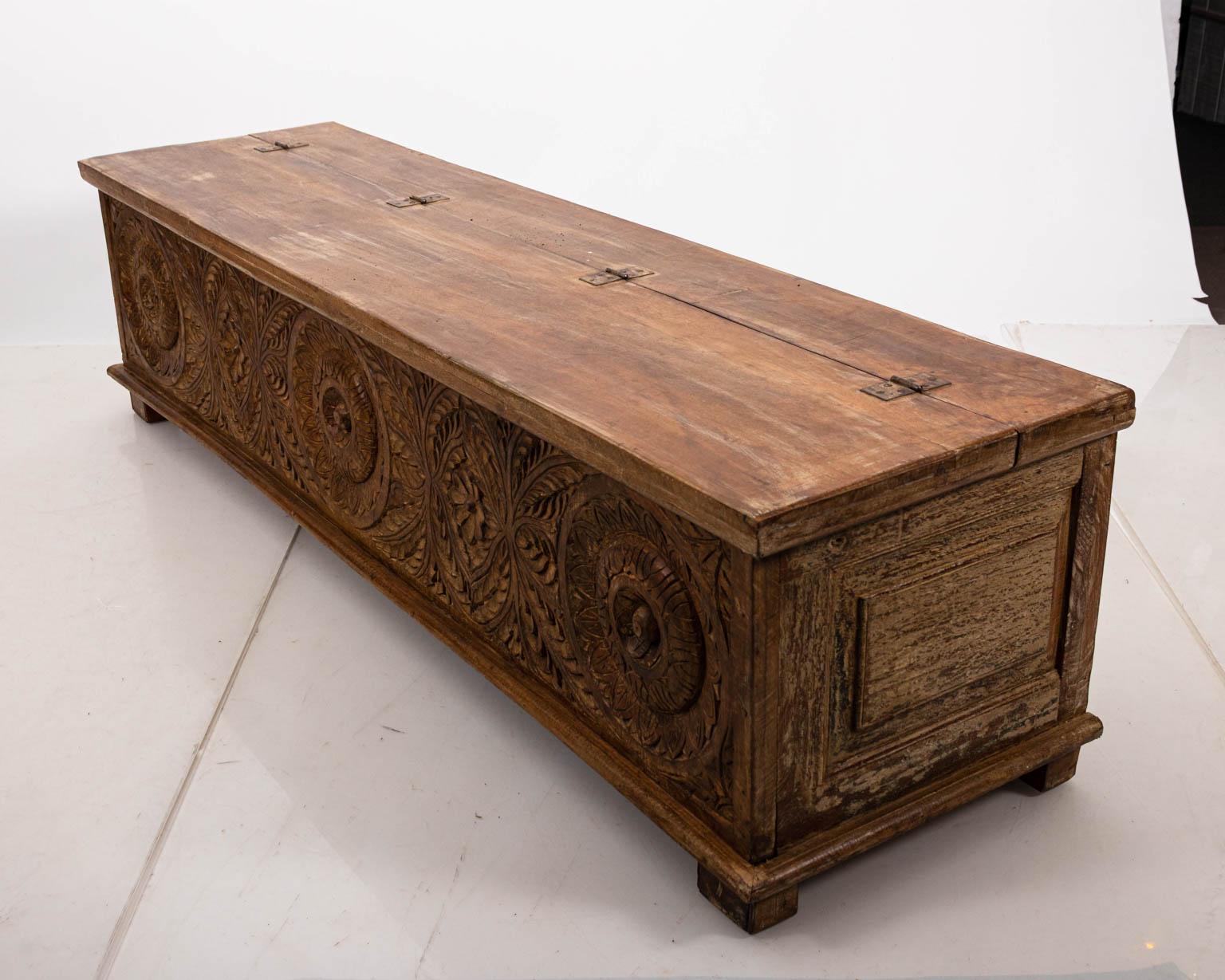 Carved wood storage box with hinged, lift top. The piece also features carved floral detail throughout. Please note of wear consistent with antique age including chips, wood loss, and scratches.