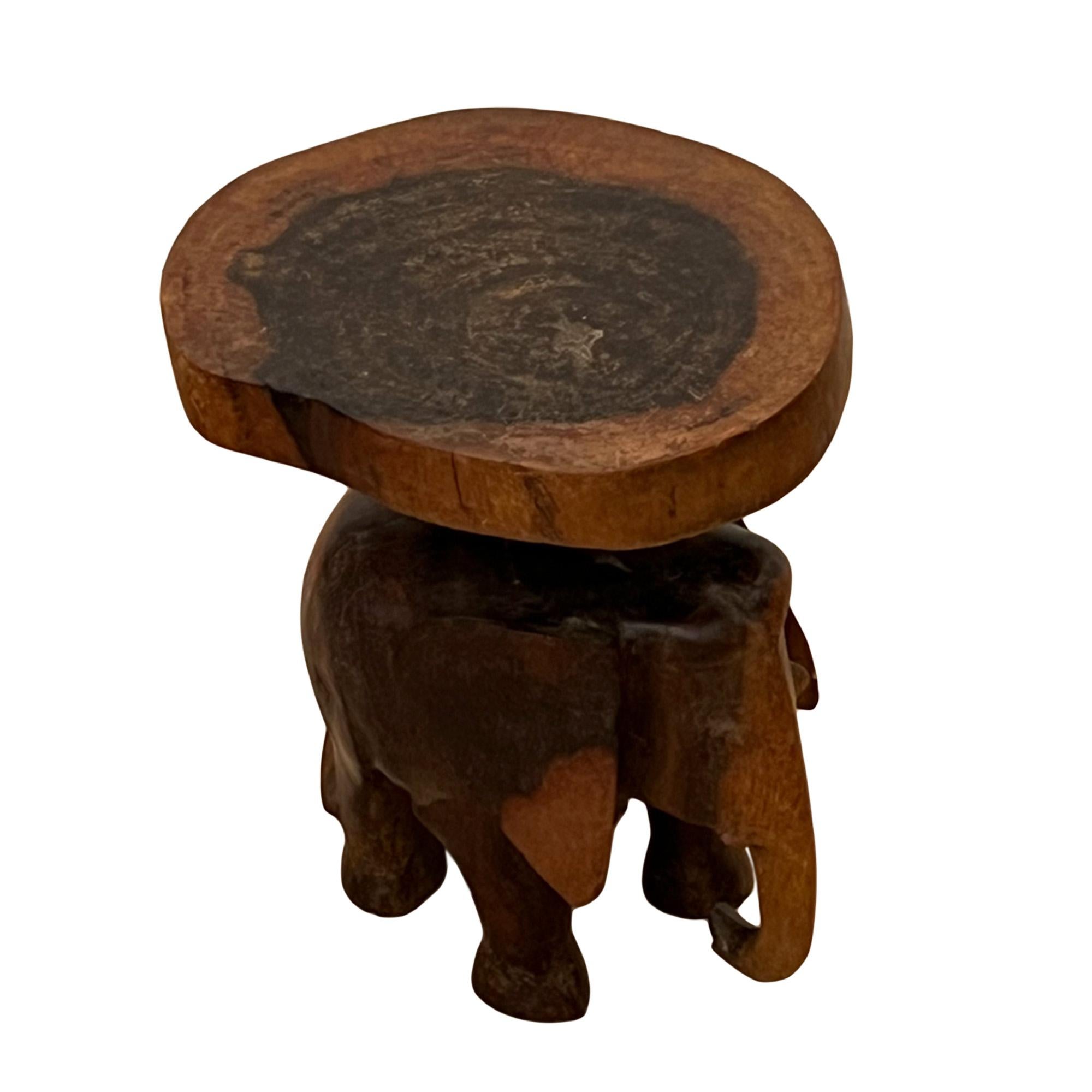 This quirky little side table was carved from padauk wood in Ceylon in the 1950s. 

Please take a look at all the pictures to see the detail of the small elephant - decorative and practical!

A lovely addition to a child's bedroom or nursery.