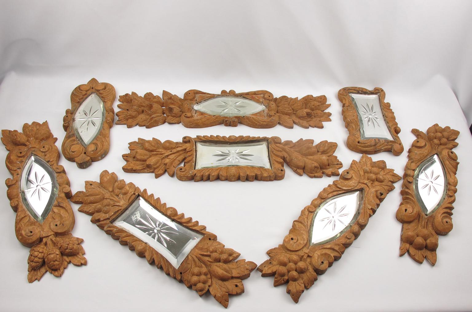 Set of eight carved wood ornaments, France, early 20th Century. Entirely all hand-carved wood architectural fragment sculpture with etched mirror insert. Carved wood fragments have been sanded in the past and were probably covered with a gold leaf