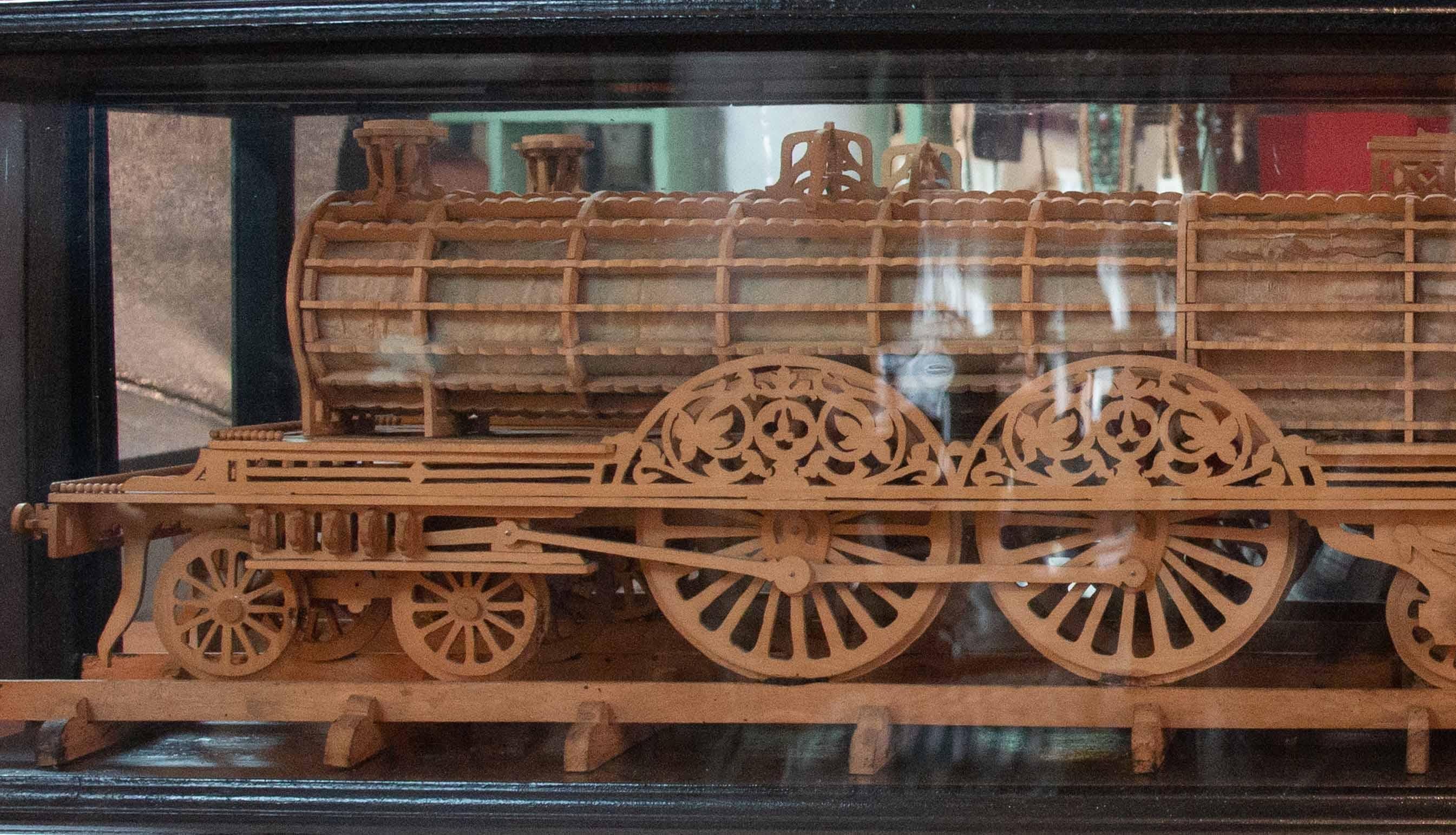 Carved Wood Model of a Locomotive in Black Lacquered and Glass Case In Good Condition For Sale In New York, NY