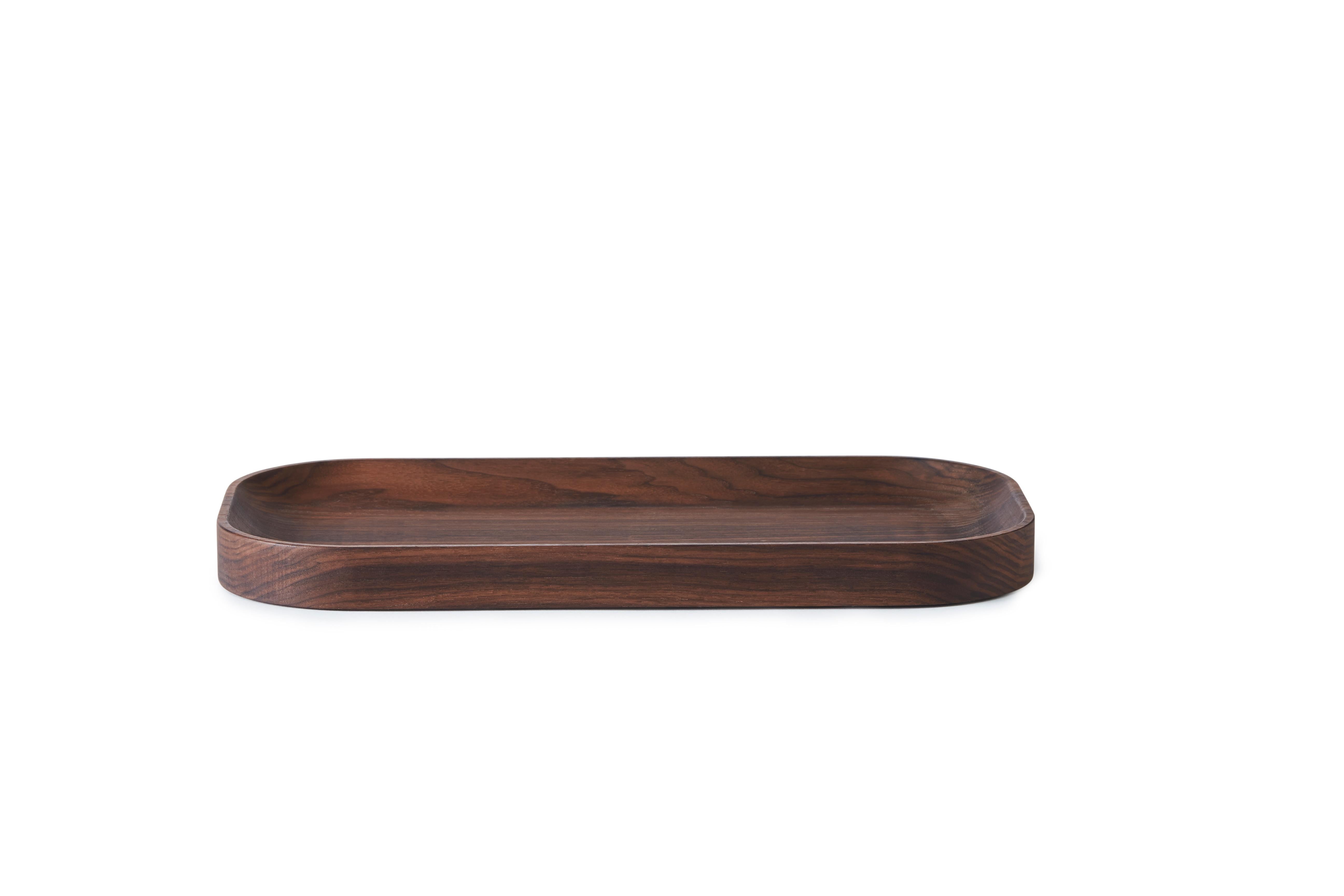 Carved wood oval tray by Warm Nordic
Dimensions: D40 x W20 x H3 cm
Material: oiled solid walnut
Weight: 0.9 kg 
Also available in different variations. 

Exquisite wooden trays with an organic design and understated elegance. The Carved Wood