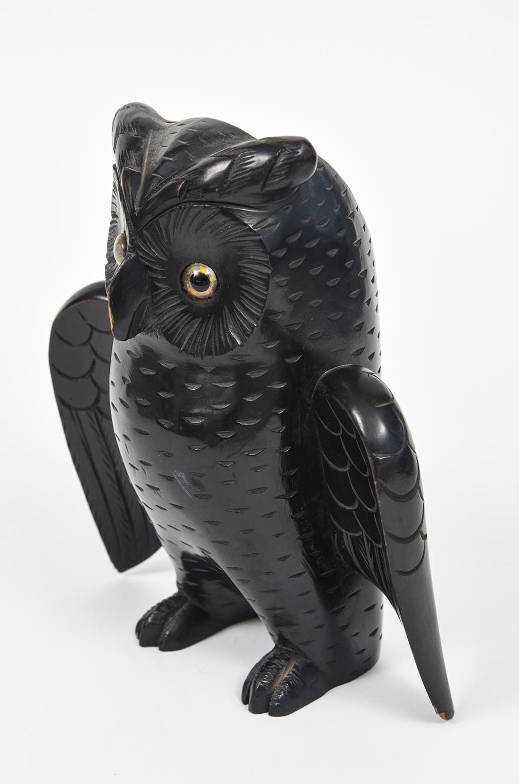Beautifully carved wood figural owl with glass eyes brush holder that can be used to store a brush used for clothing, shoes, fireplace, or crumbs. It has an area on back to be mounted on the wall or used freestanding. 