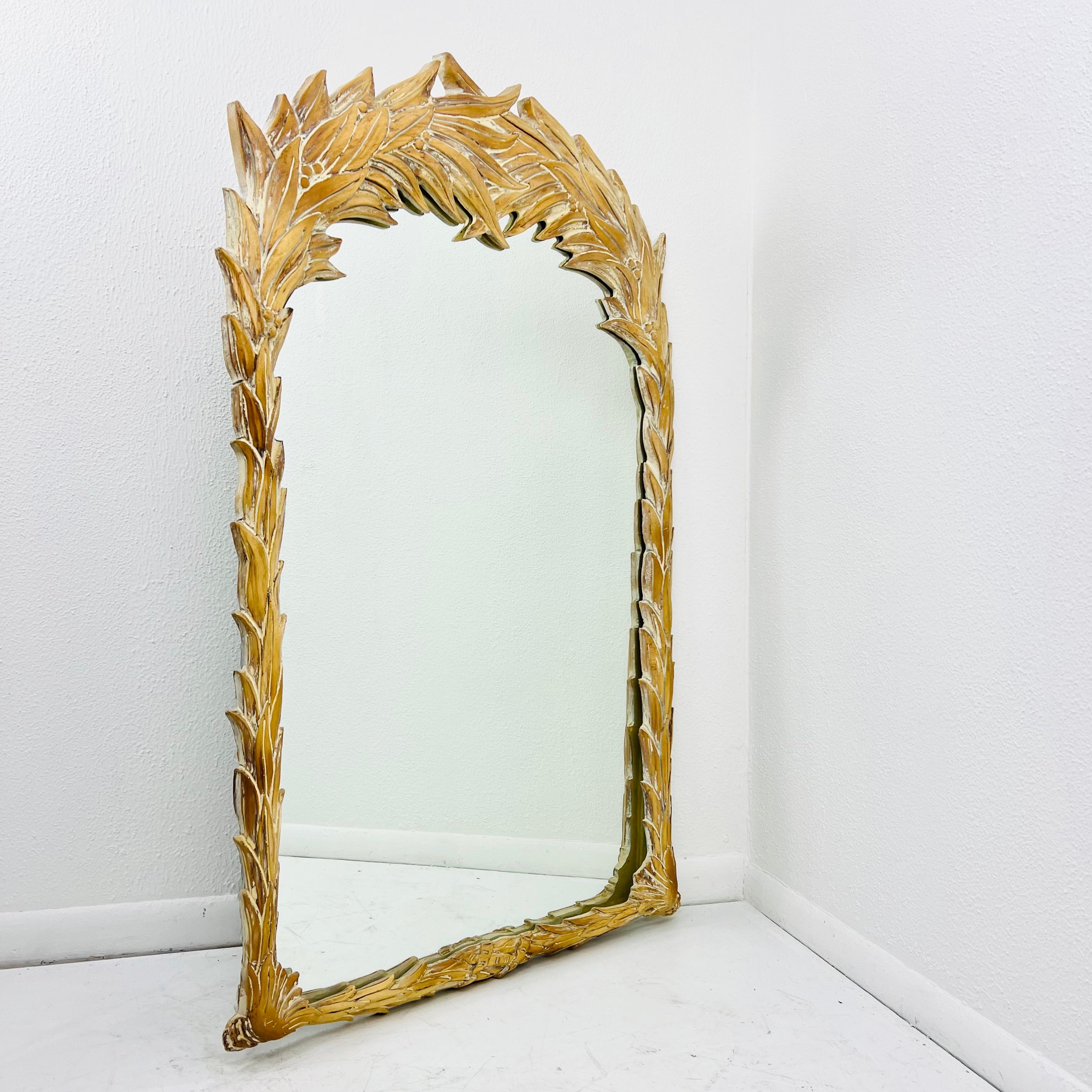 Sculptural palm leaf wall mirror in the manner of modernist designer Serge Roche. Whitewash finish accents the gorgeous details in the sculptural palm fronds surrounding the mirror. Good vintage condition with one chipped edge of frame (pictured).