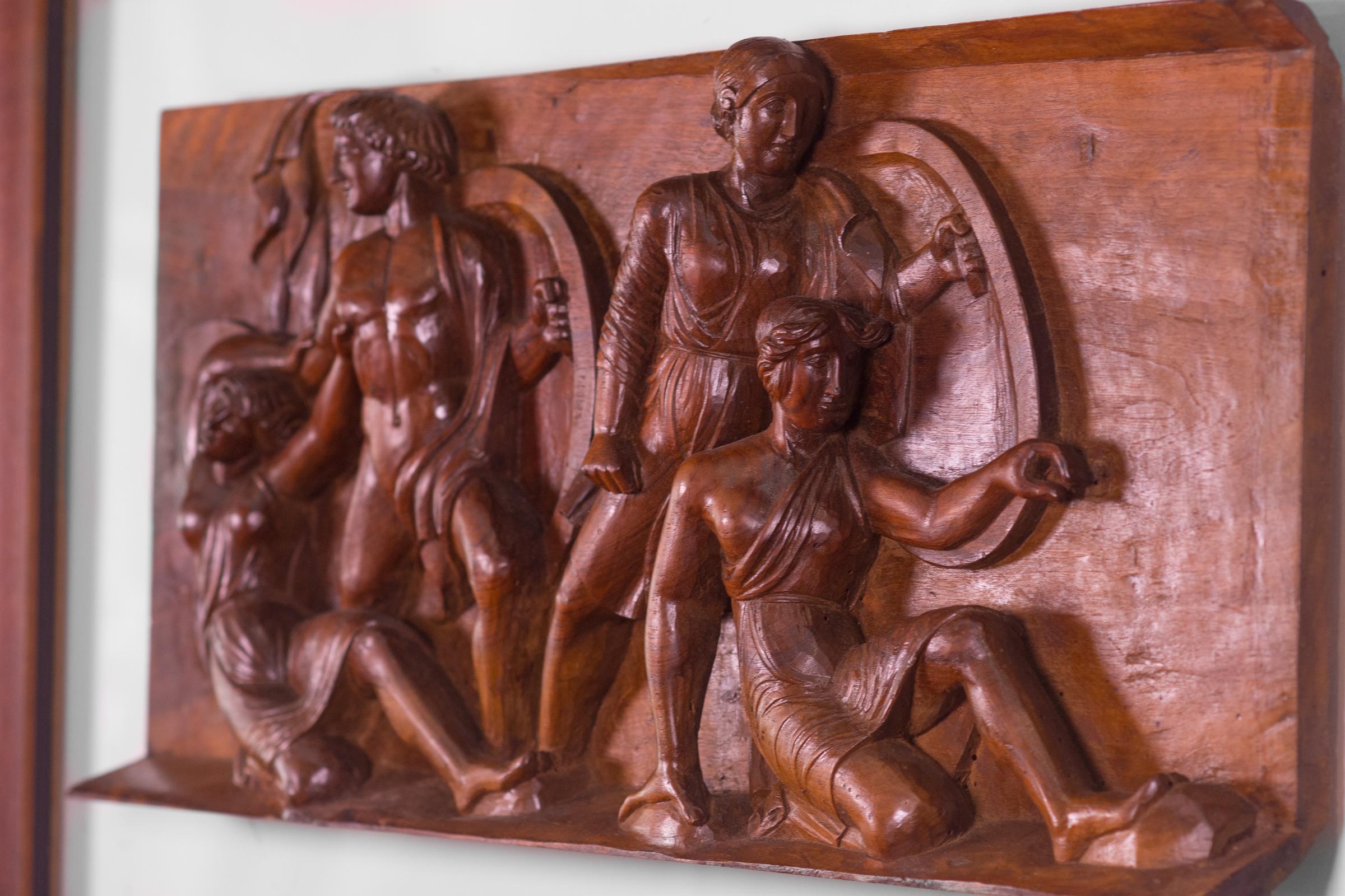 1920s French walnut carved-wood panel of part of the Frieze of the Parthenon. It shows the procession of the Panathenaic festival, the commemoration of the birthday of the Goddess Athena. The piece is mounted on a Lucite panel and framed with two