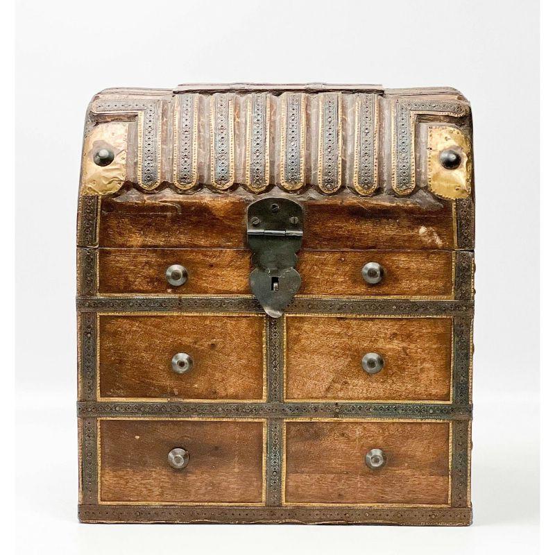 Carved wood patinated and gilt metal treasure chest form decanter tantalus box

circa 1920. Wood box with divided interior to fit 6 decanters, patinated metal and gilt metal mounts to to create the appearance of a treasure chest.

Additional