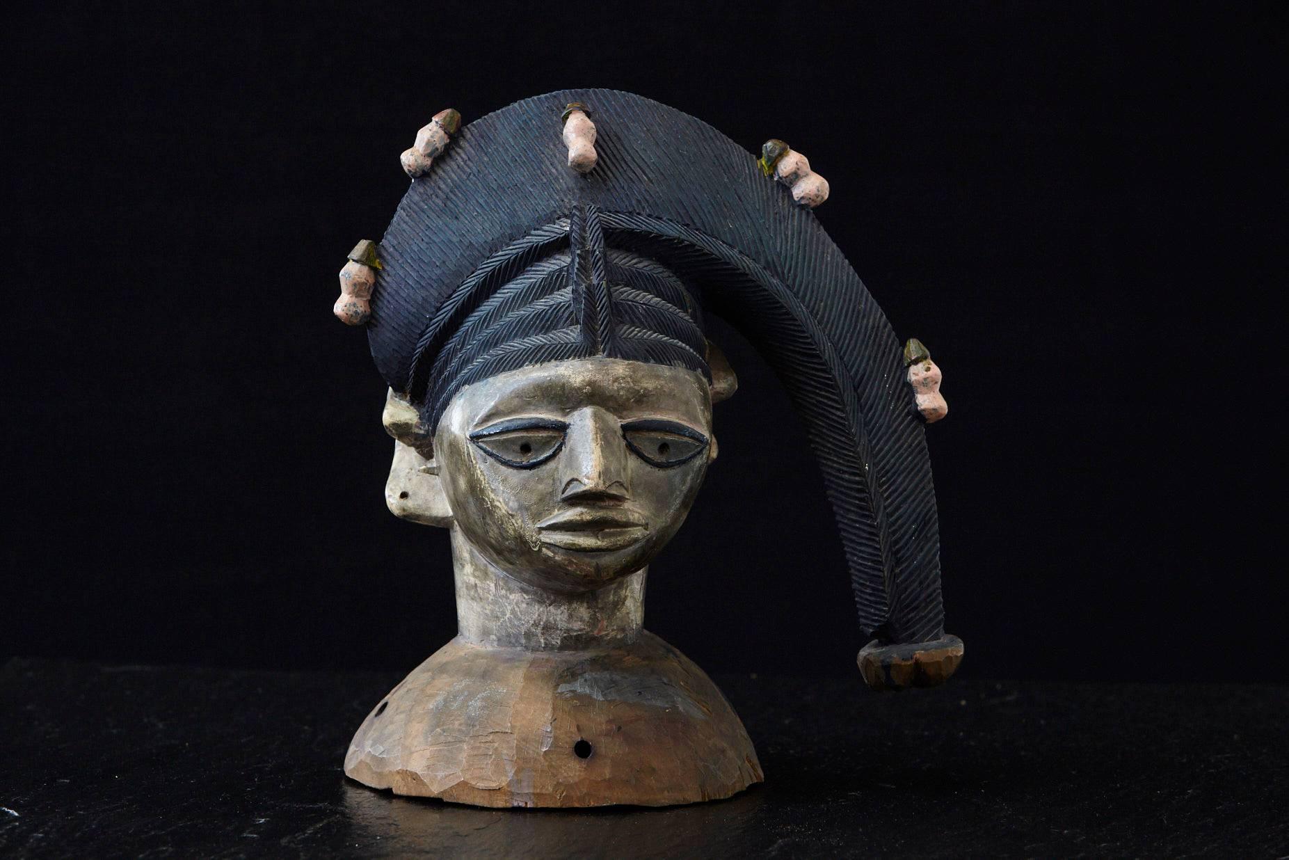 Polychrome Egungun Oyo headdress (ere egungun olode), Yoruba, Oyo State, Nigeria, circa 1930-1940, maybe earlier.
The headdress is elaborately carved from one piece of wood and colored with pigments.

While the style of carving varies widely