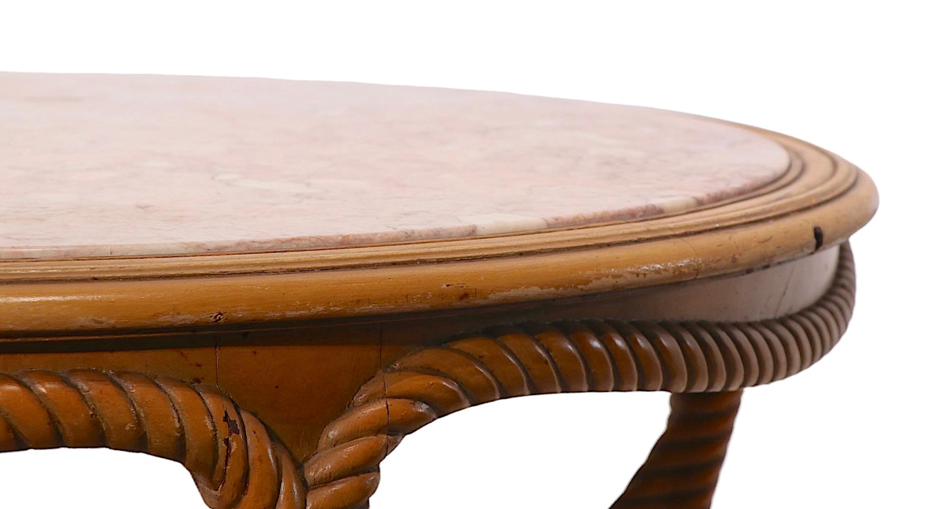 Stylish rope twist carved wood coffee table with rouge marble top. The table is in good, original, estate condition, showing only light cosmetic wear, normal and consistent with age (slight flaw in the finish at the top edge, please see images). 
