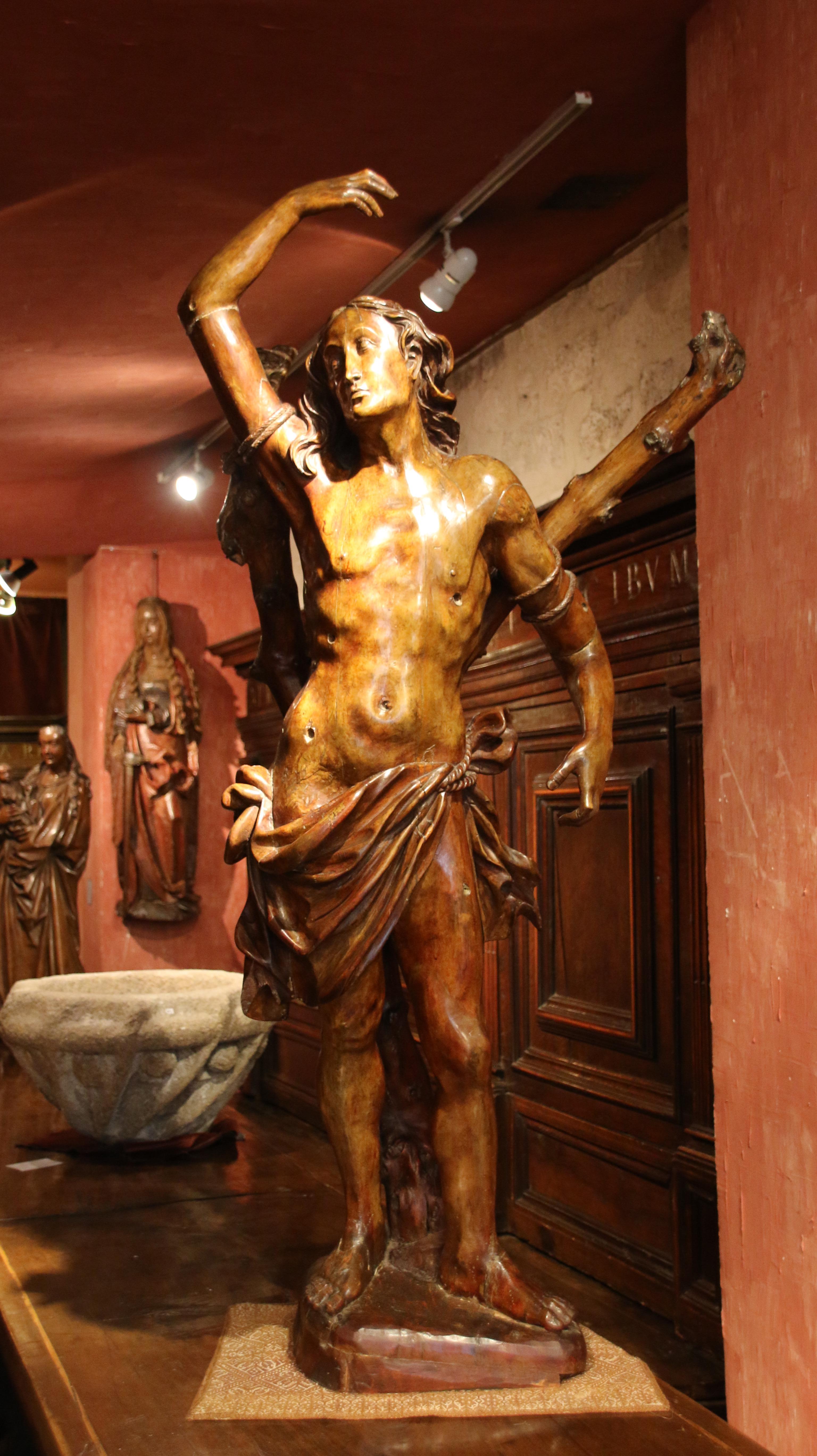 Carved wood Saint Sebastian

Origin : Southern Germany
Period : c. 1510-1520

Measures: Height : 146 cm
Width : 67 cm
Depth : 30 cm

Walnut
Good condition

According to Jocobus de Varagine’s Golden Legend Sebastian was born in Narbonne