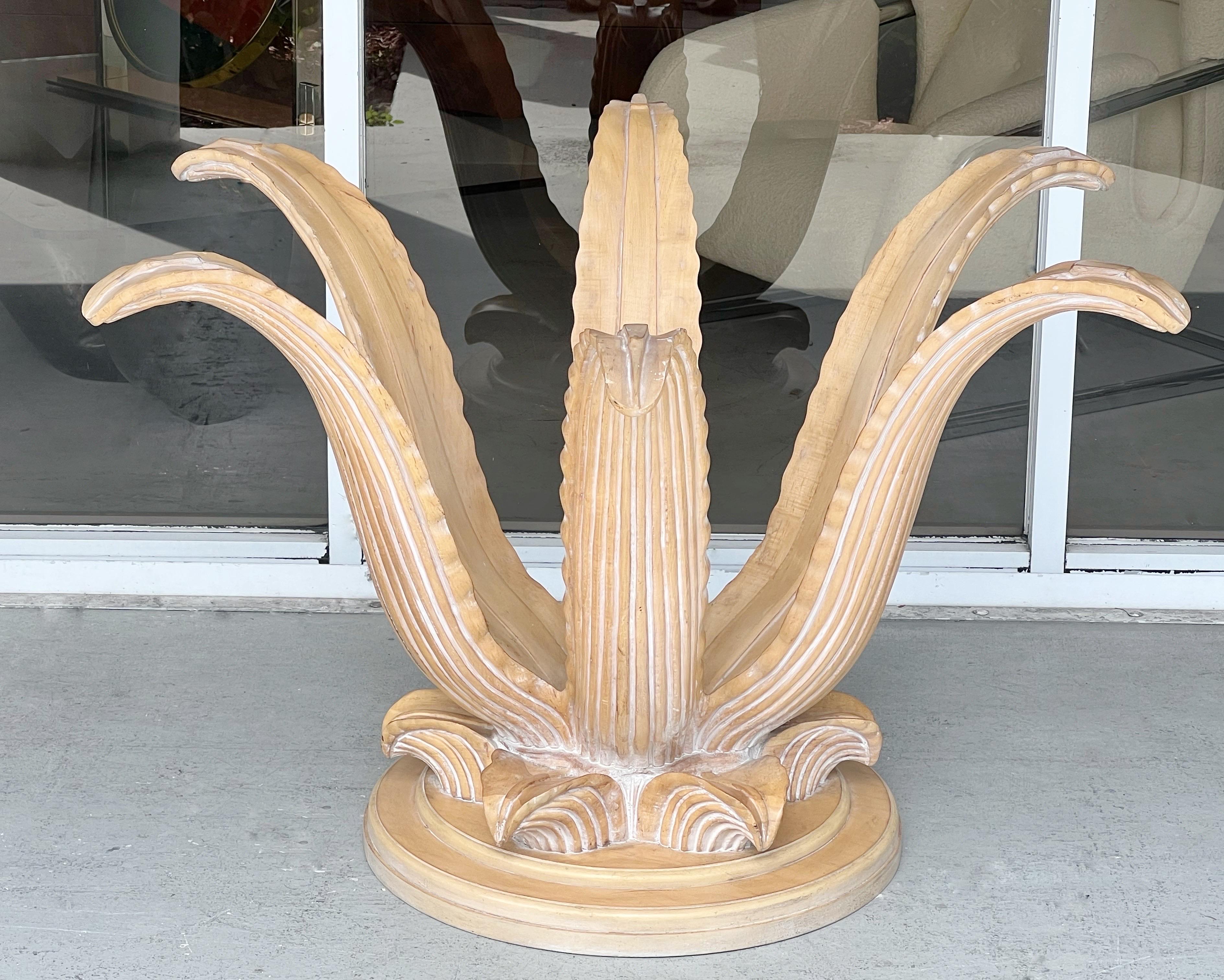 A 1970s carved wood dining table. A lifesize stylized agave plant with the leaves supporting the 60” diameter glass top. Ned’s new top. Carving is subtle and lines are graceful but restrained.