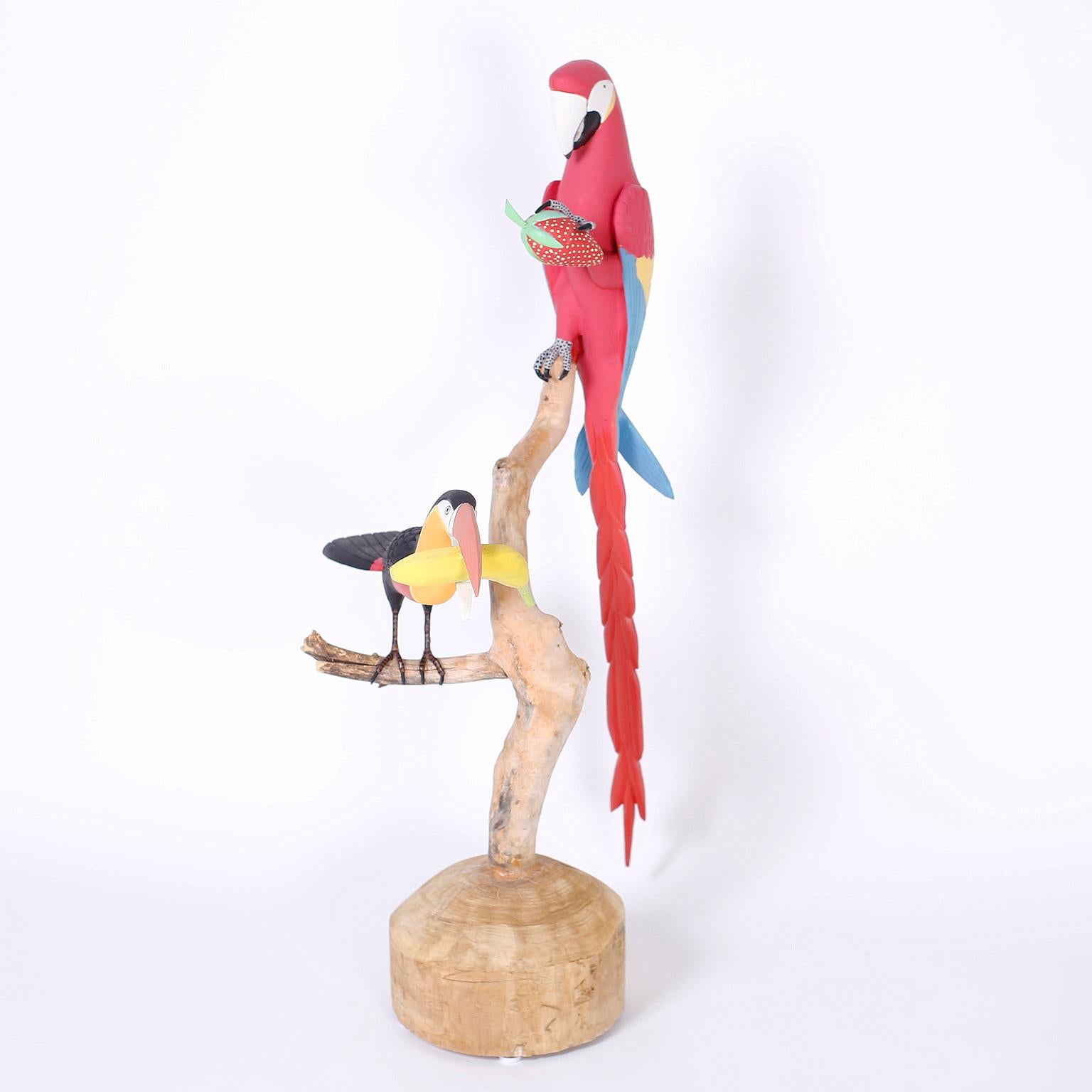 Sculpture of a parrot with a strawberry and a toucan with a banana created in wood and decorated with tropical colors. Signed by the noted artist Leroy Ortega on the bottom.