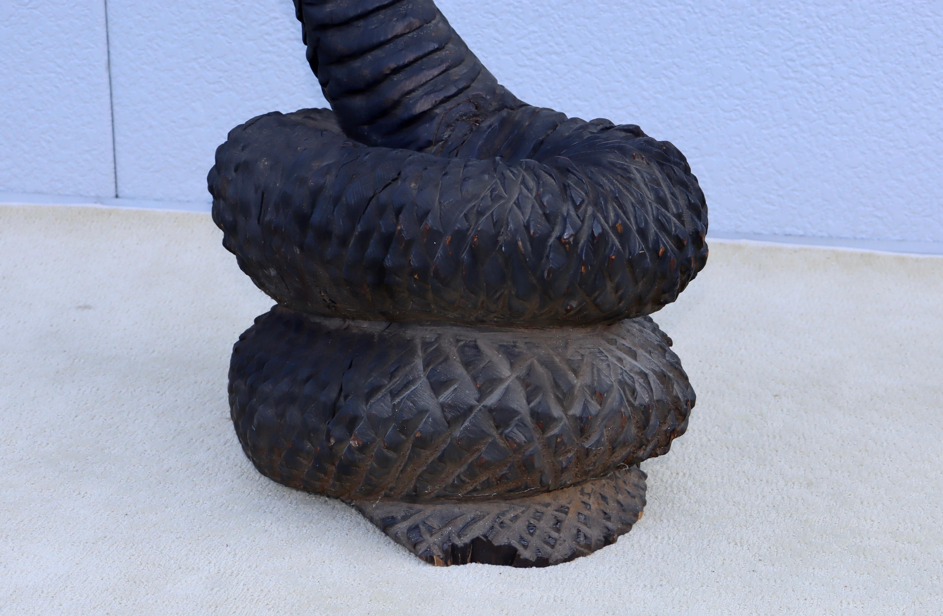 1970's carved walnut snake chair sculpture, in vintage original condition with some noticeable wear with some cracks to the wood and minor loses, the sculpture is signed by the artist.