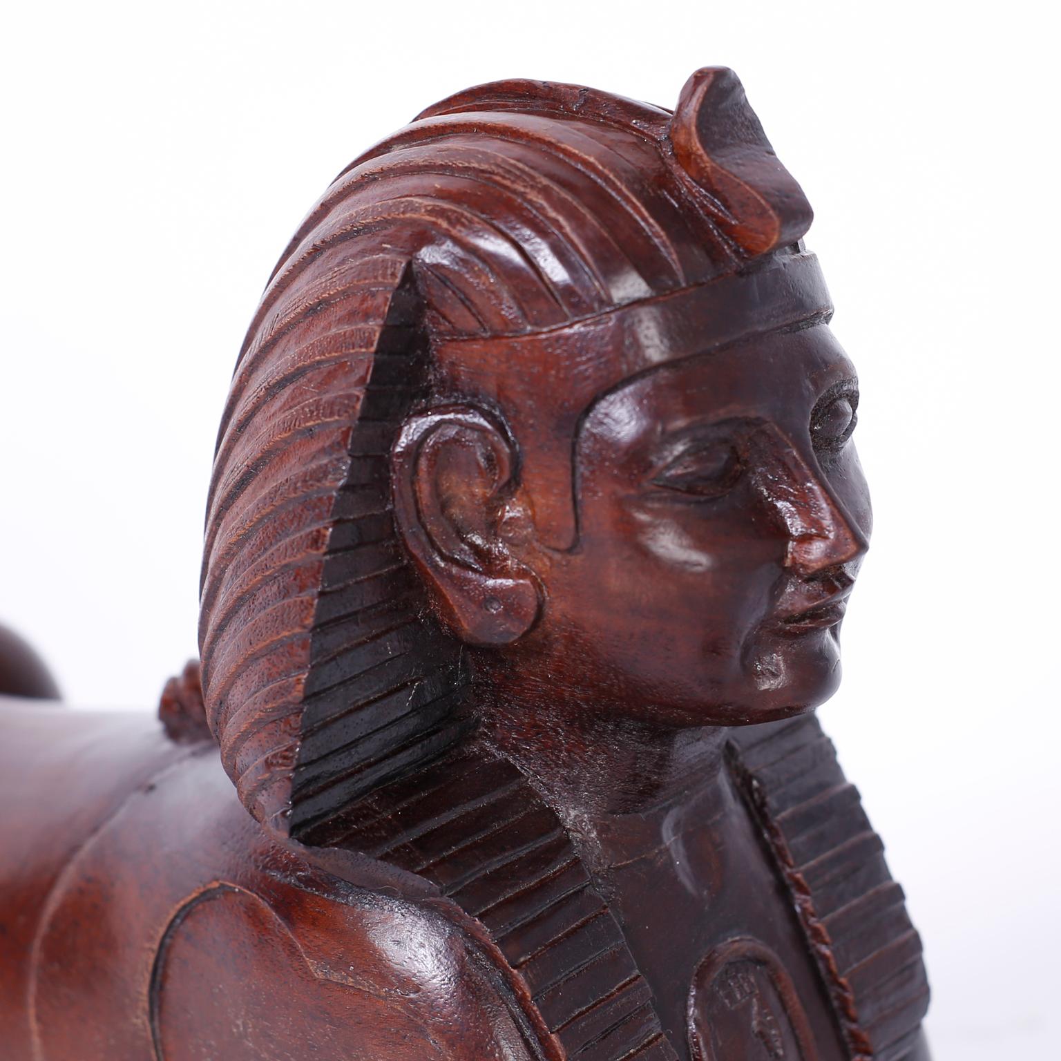 Antique carved mahogany replica of the iconic sphinx on a rectangular base.