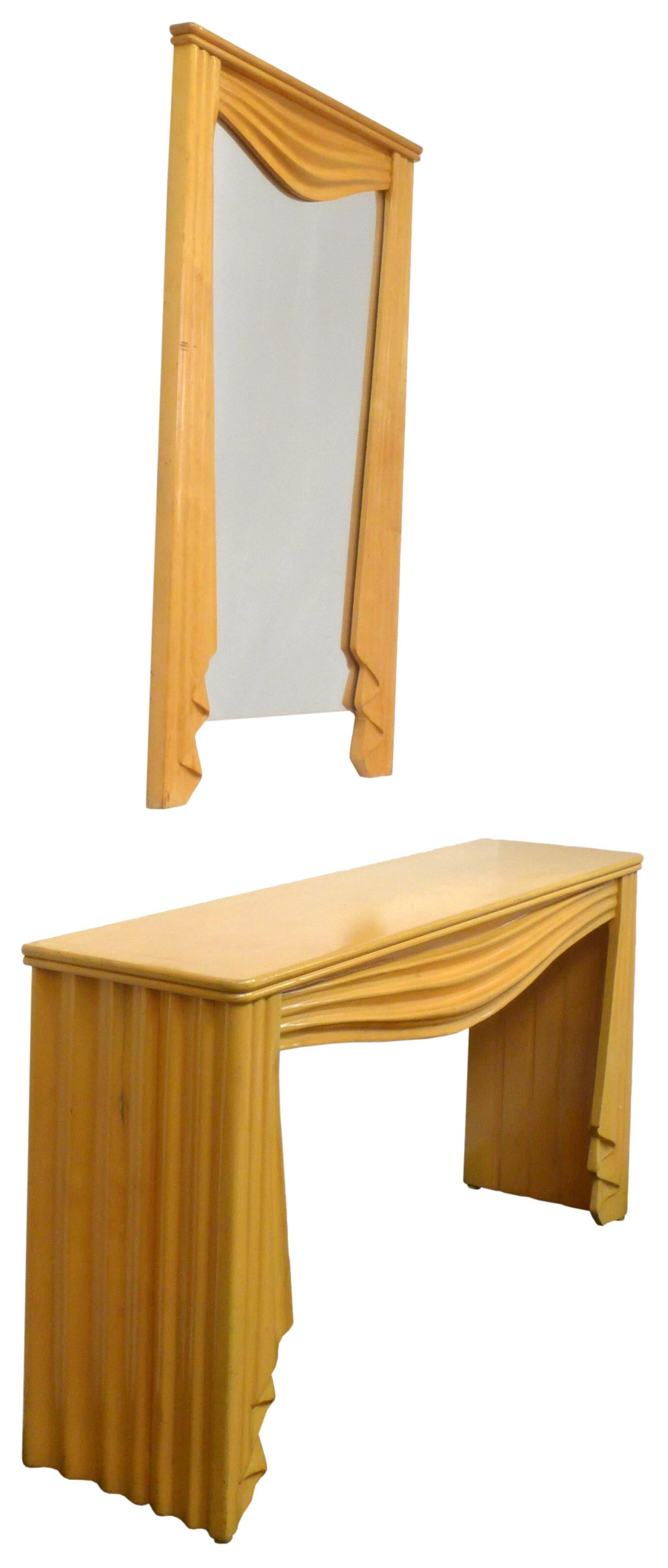 An Italian, carved maple console table and coordinating wall mirror. Very surrealist in feel with the execution of carved wood elements implying draped and undulating fabric. A Trompe-l'œil material effect created by this playful and creative