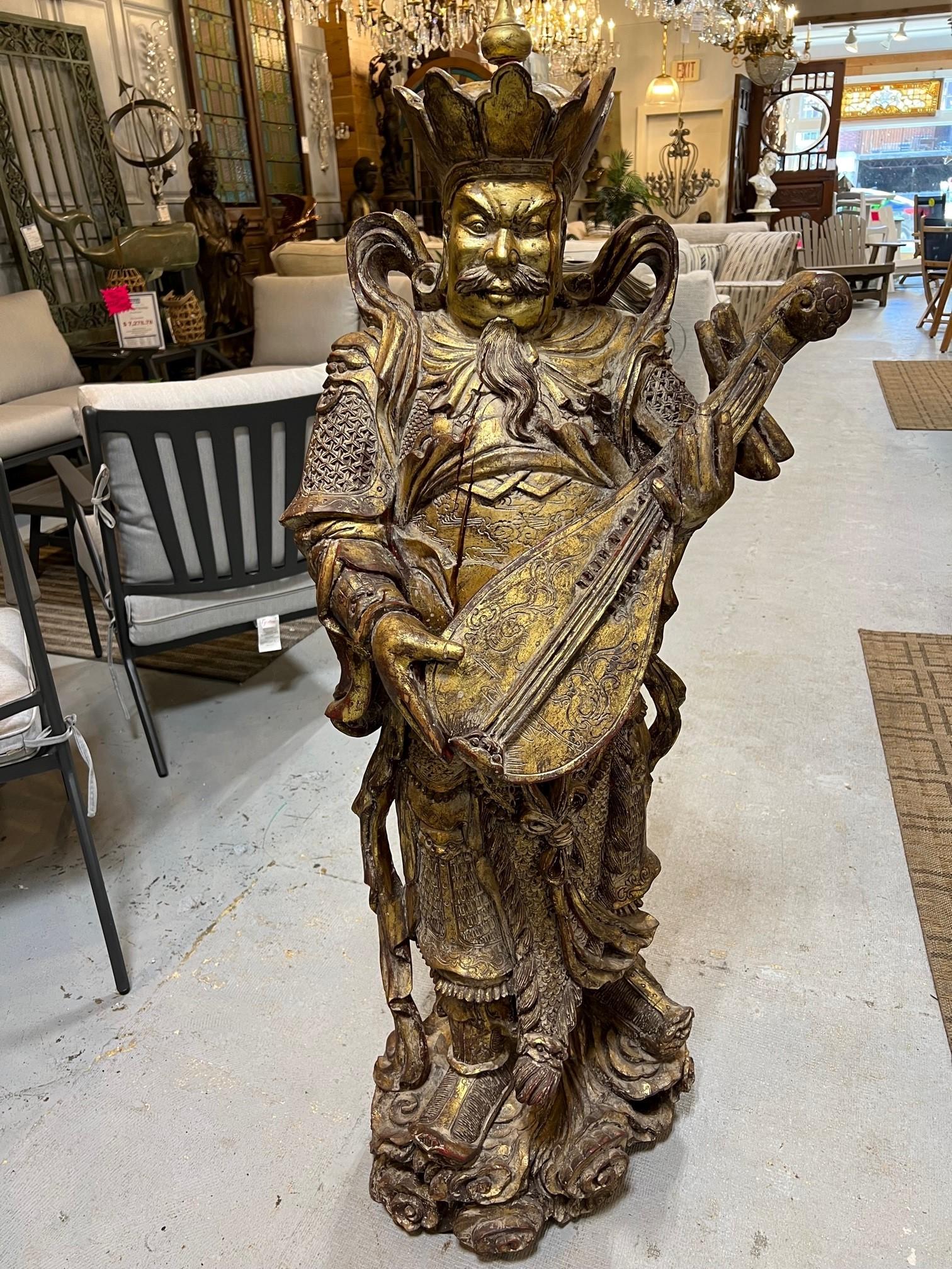 Early 20th century carved wood Tibetan Warrior God playing a Liuqin or a Chinese mandolin. I believe this is Dhritarashtra who is a major deity in Buddhism and one of the Four Heavenly Kings. His name means 