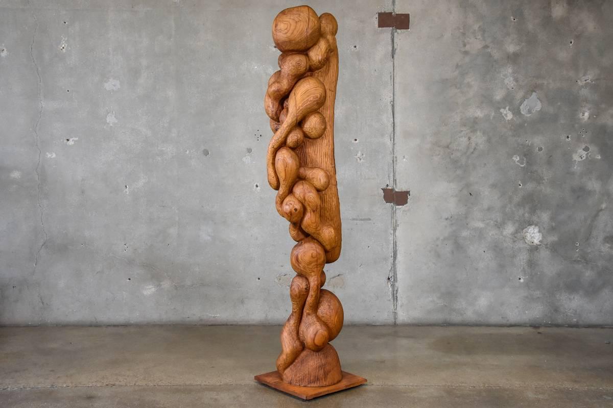 Incredible carved wood sculpture by Omaha artist Les Bruning. Carved in solid ash, the piece is signed and dated 1975. In original condition with some wear consistent with age.

Measures: 82