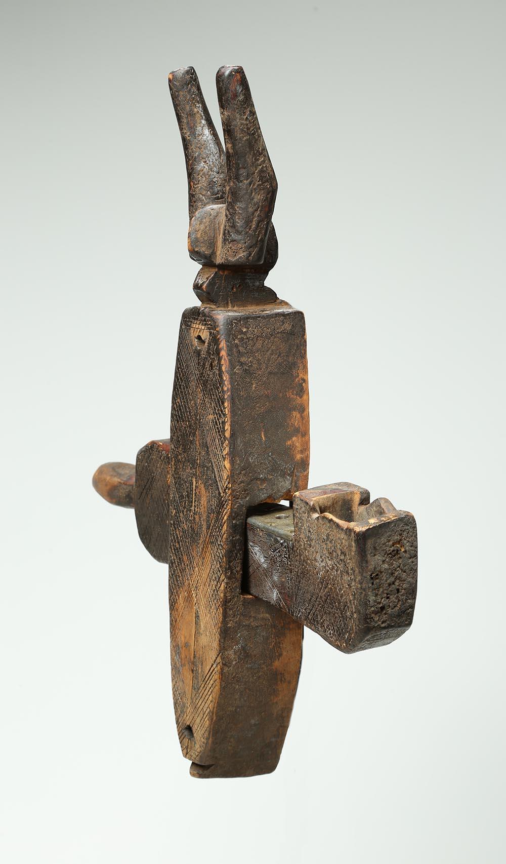 Well-used wood door lock used by the Bambara people, Mali, Africa, with crosspiece. The top is an animal head with horns possibly an antelope. Includes original movable bolt or crosspiece. Heavy wear and encrusted patina from extensive use. Stylized