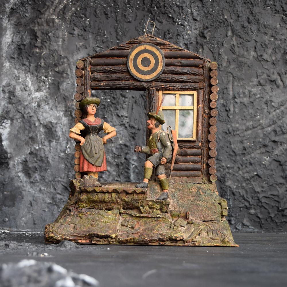 Carved wood Tyrolean model of a hunting lodge, circa 1880.
We are proud to offer a most unusual circa 1880 carved wooden Tyrolean model of a hunting lodge with carved and painted Folk Art figures and painted bullseye target under roofline. A highly
