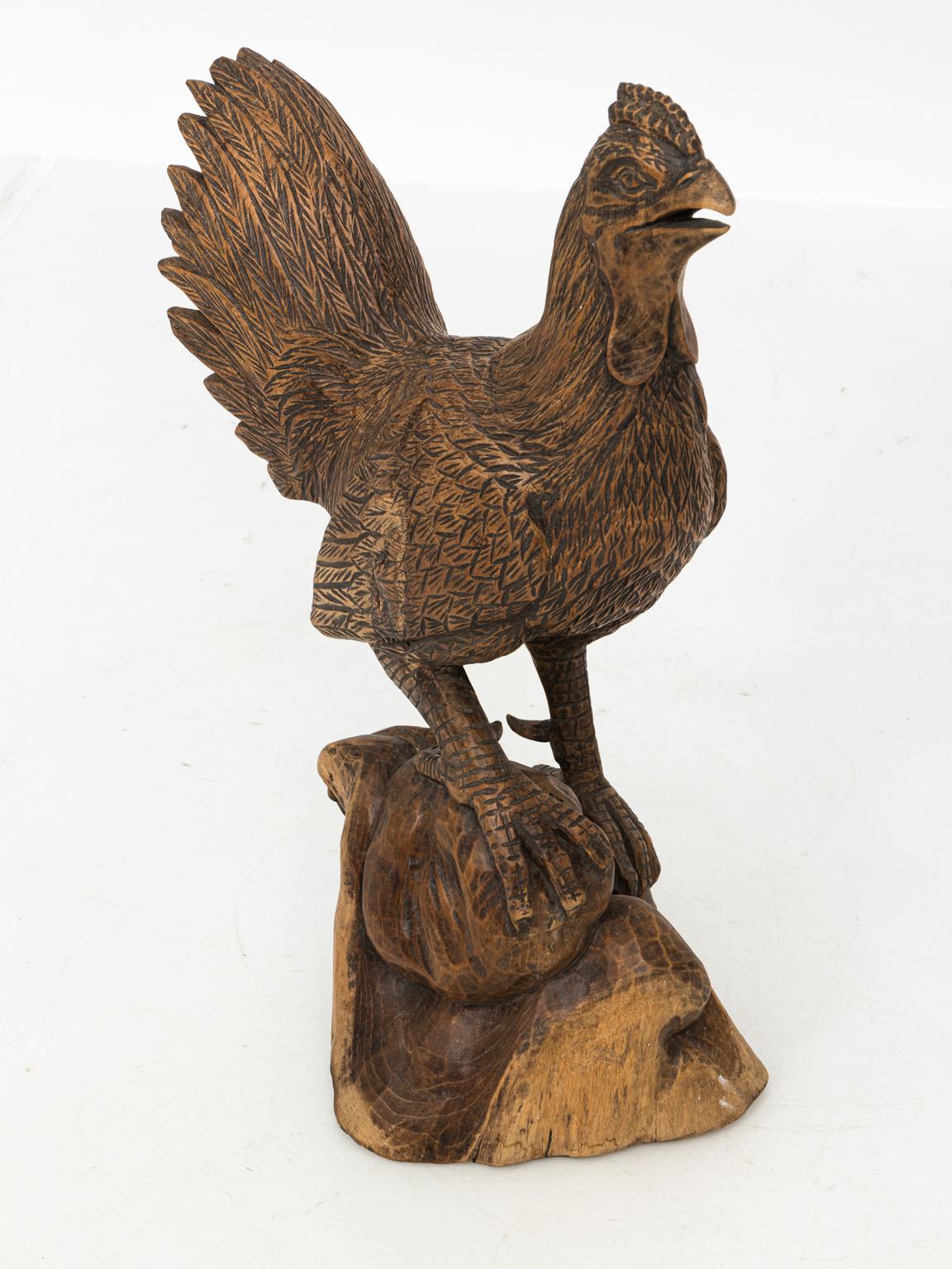 Antique carved wooden chicken, possibly from Asia. Please note of wear consistent with age including wear on the base and a small crack in the tail.