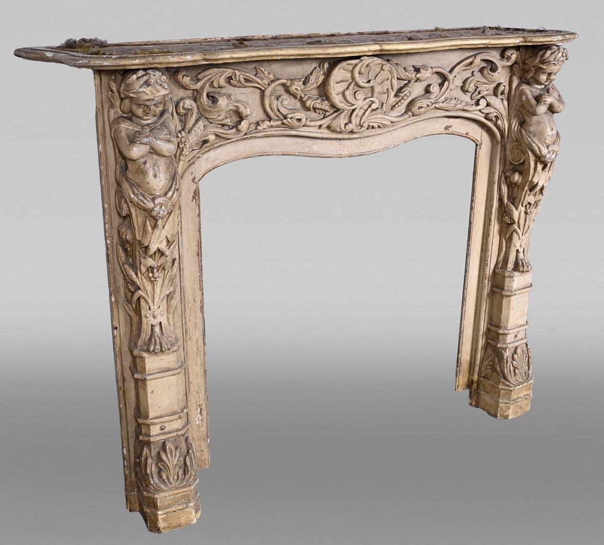 Chimenea de madera tallada con decoración de putti - Finales del siglo XVIII en Bueno estado para la venta en SAINT-OUEN-SUR-SEINE, FR