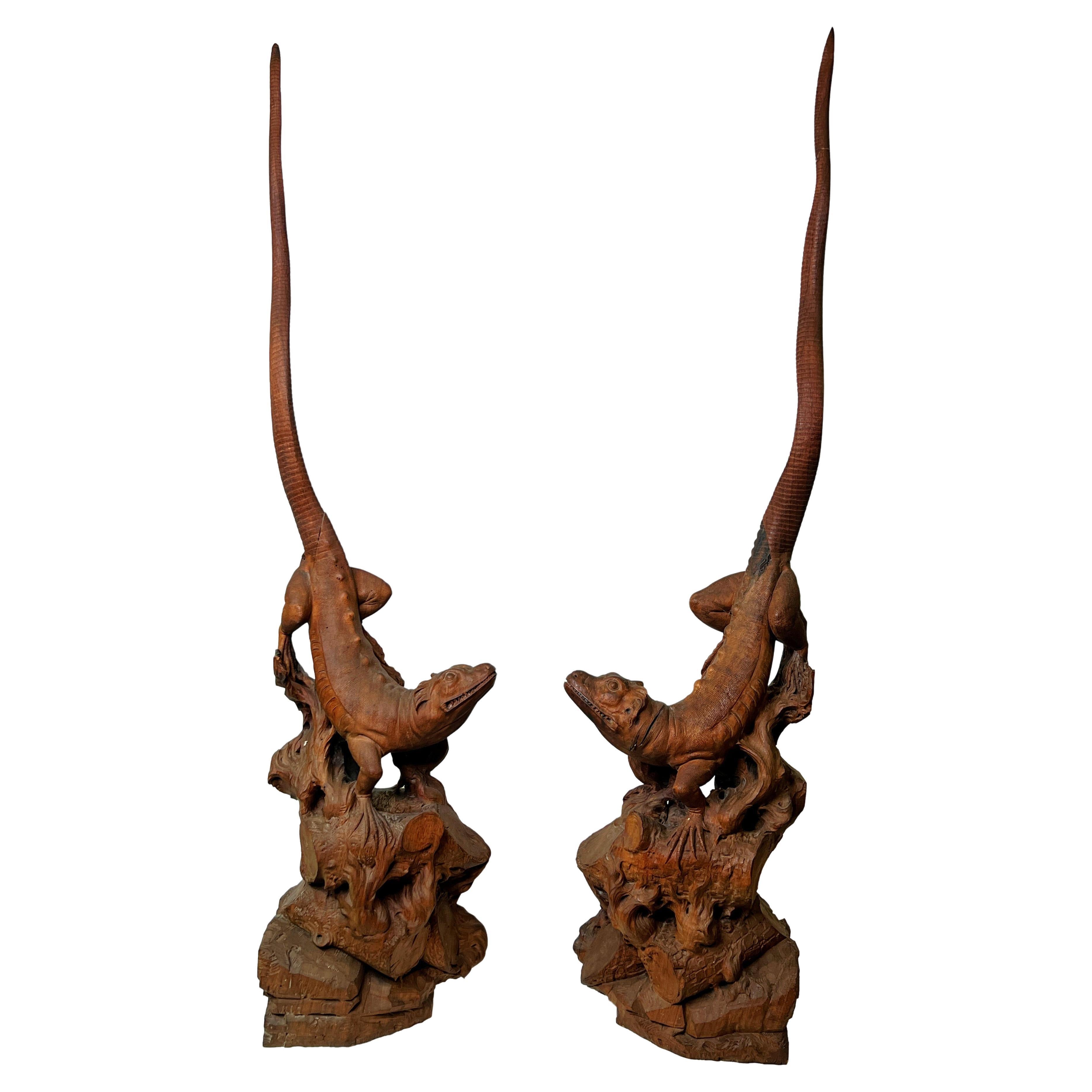 Our exotic pair of carved lizards measure 47 and 49 inches tall respectively and exhibit extraordinarily realistic details. Apparently unsigned, dating from the early 20th century, and believed to be of Asian origin. One side and rears are flat so