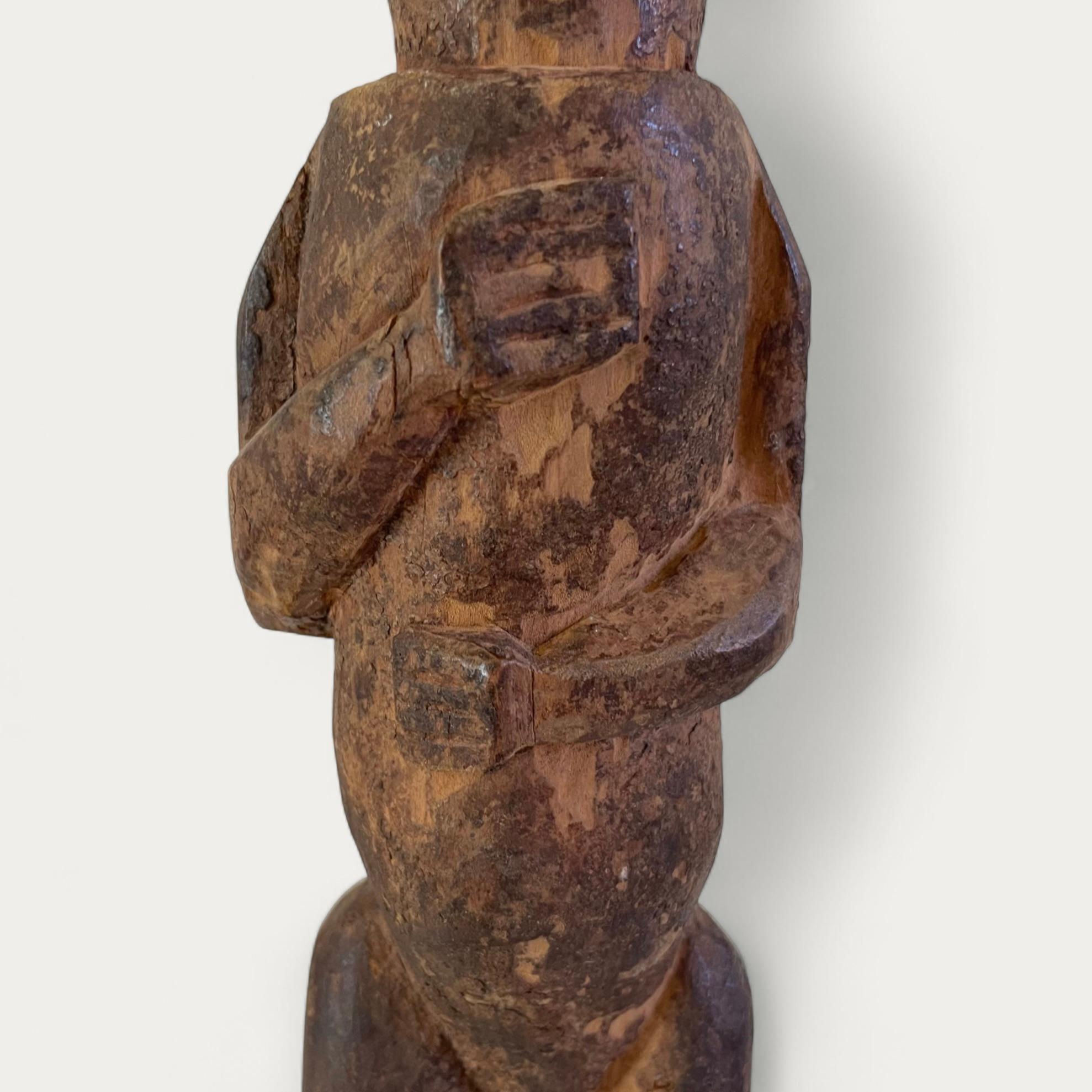 This wooden male statue, of the Yanzi people of the Democratic Republic of Congo, is carved in wood with traces of ‘Tukula’ pigment, characteristically elongated and stylised features, and legs slightly bent in a dance pose. From the first half of