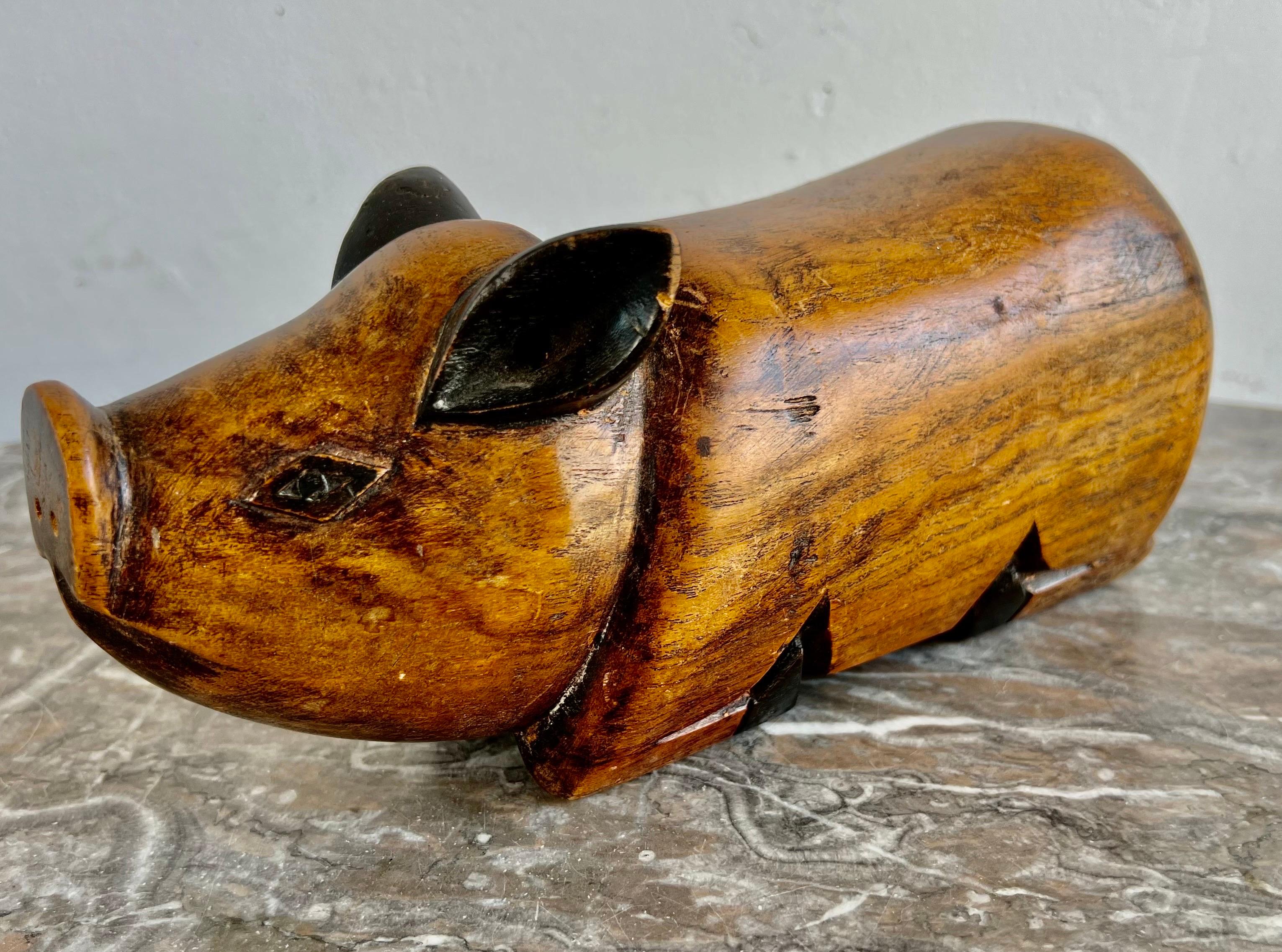 Hand carved wood pig with a secret hidden compartment on the bottom for your favorite treasure.
