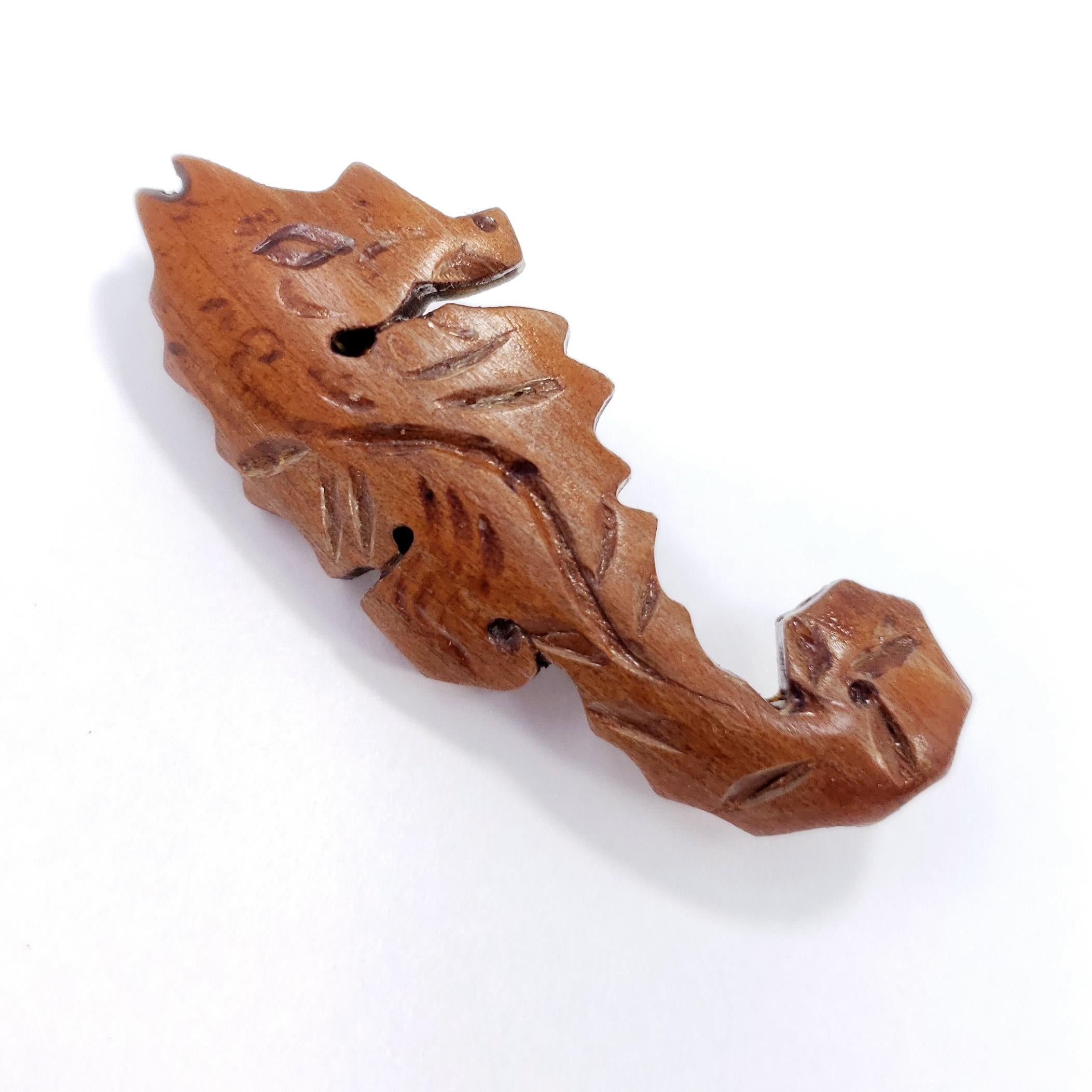 A stylish wooden pin, featuring a carved seahorse. Vintage, mid to late 1900s.

Hallmarks: n/a