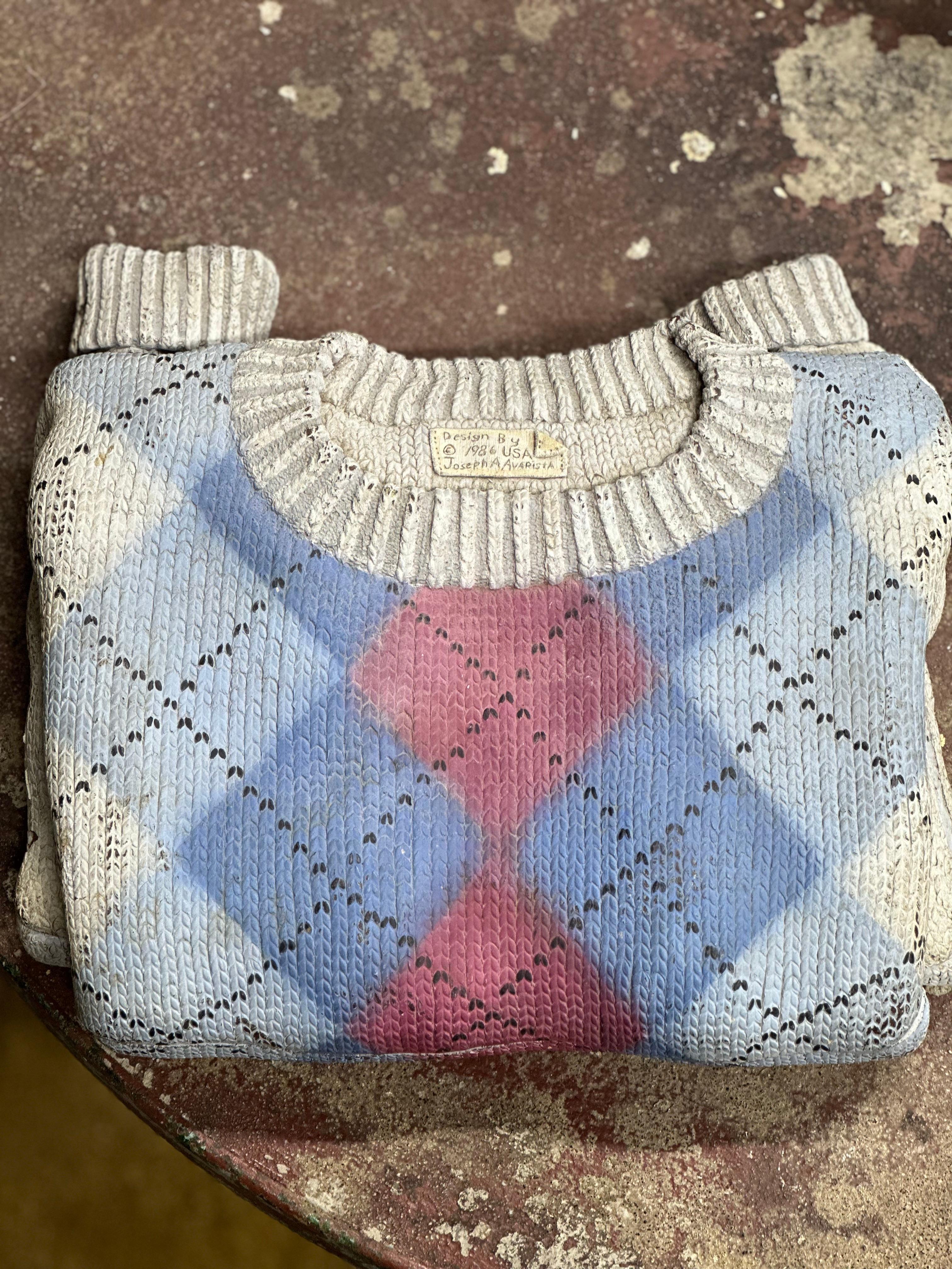 Wooden carved argyle sweater carved and painted by Joe A Avarista. Avarista was commissioned to make a series of sweater boxes to house a set of rare ink pens. This box is one of a kind as there are no other sweaters in this style. Joe Avarista is