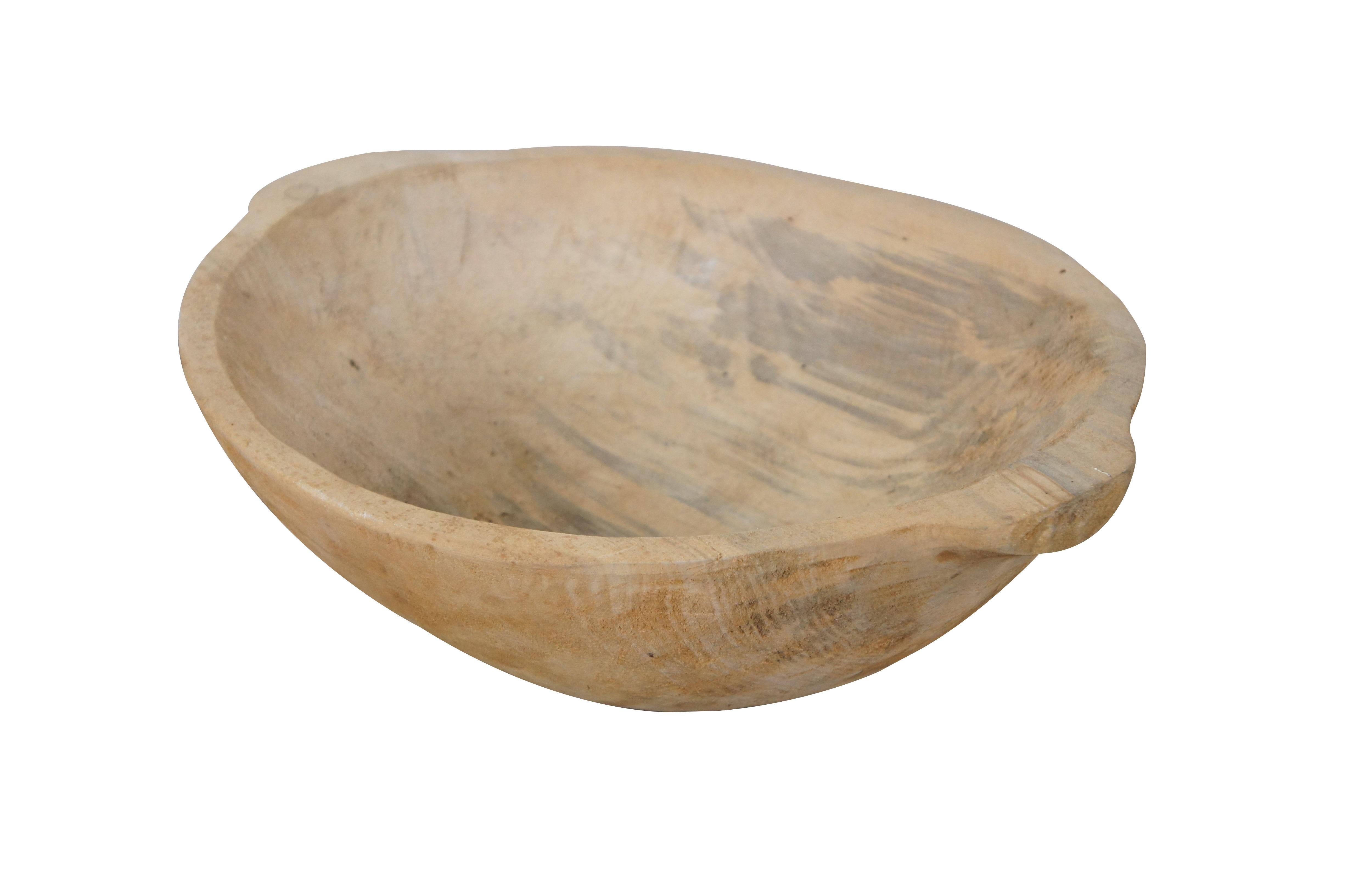 Primitive folk art style carved wooden trencher dough bowl, featuring two handles.  Signed “Clarren Williams Box 2340 Redfox, KY” in ballpoint pen on the base. 

Dimensions:
16” x 13.25” x 4.75” (Width x Depth x Height)