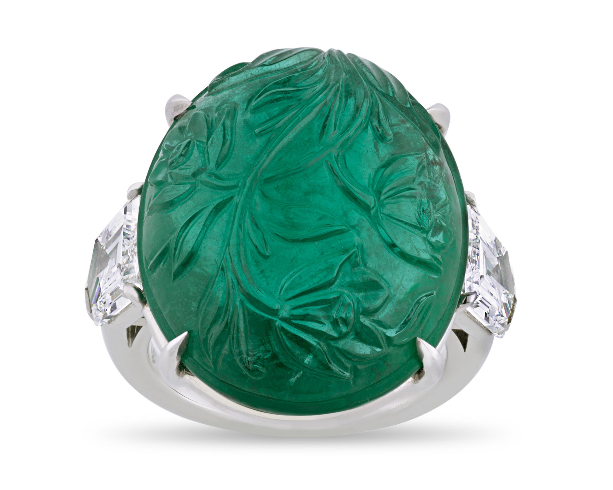 This ring possesses a stunning example of the ancient and complex art of gem engraving. Intricately carved in a rich floral design in the Mughal taste, the impressive 24.05-carat emerald in this ring is certified by C. Dunaigre. Emeralds from Zambia