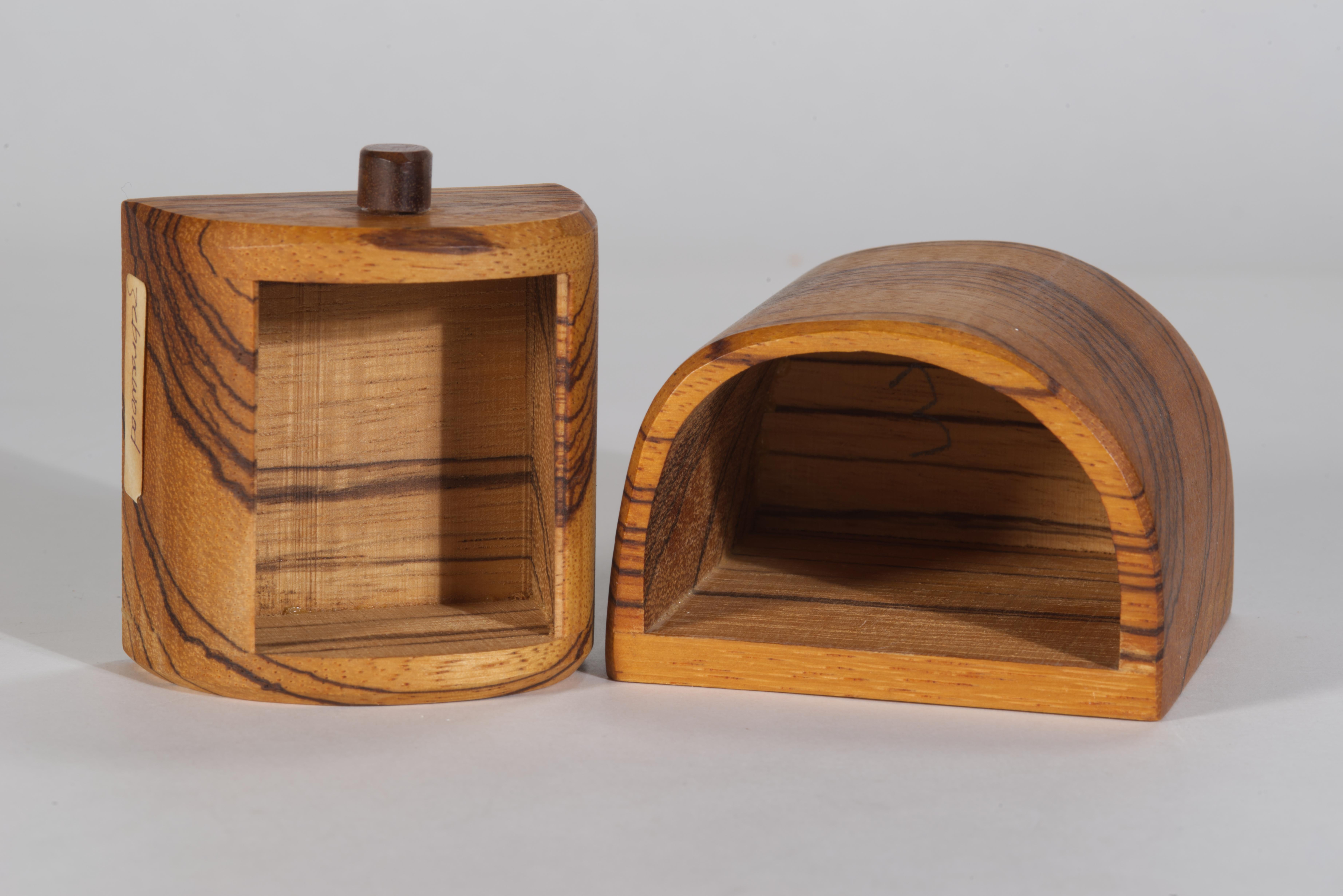 Vintage small decorative trinket box with pull-out drawer compartment features handcrafted sculptural form, carved of solid Zebra wood. The fine wood texture is emphasized by the graphic shade variations of the wood grain, and the semi-matte tung