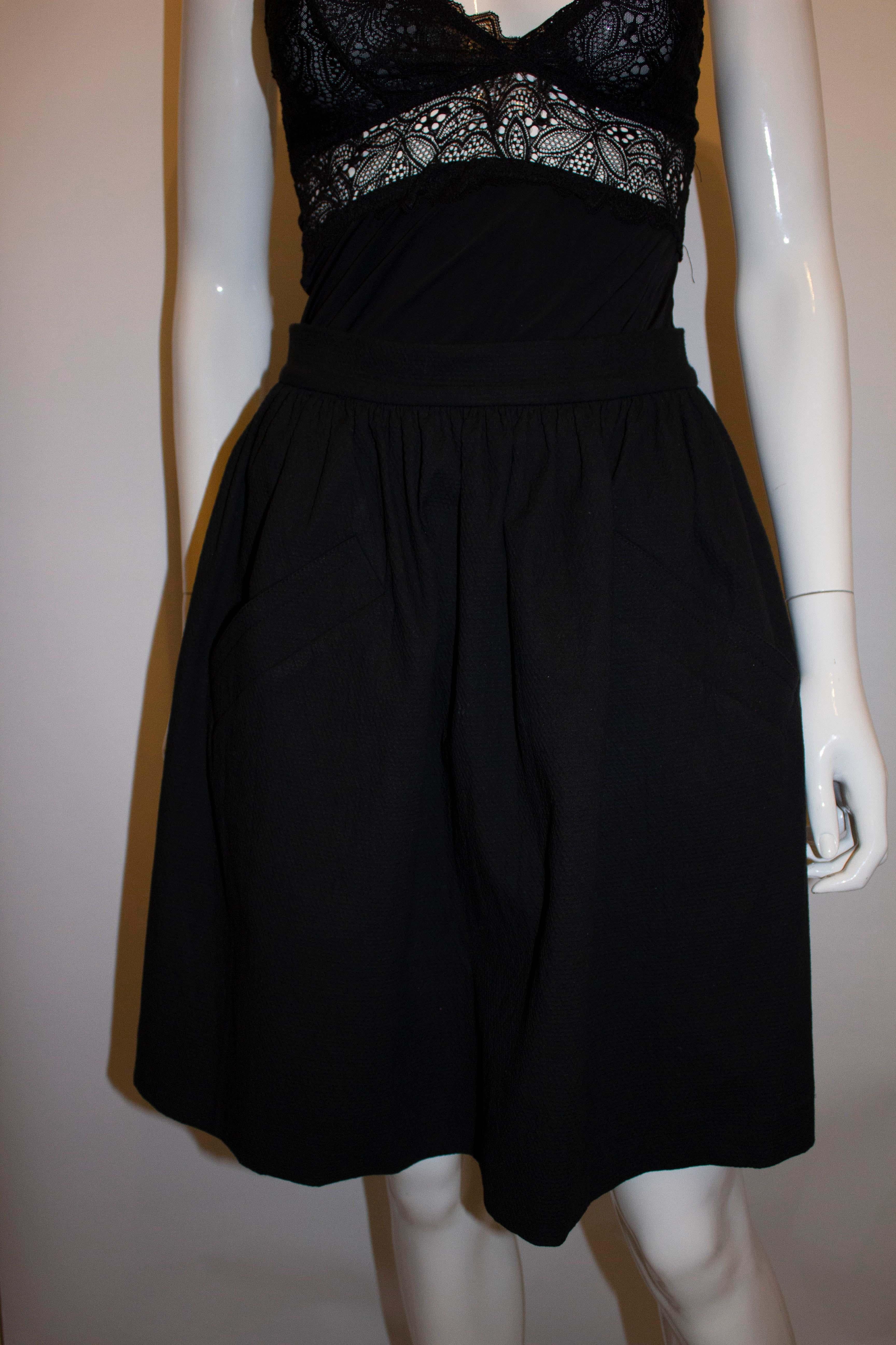 A fun black cotton skirt by Carven. The skirt has gathering at the waist , a back central zip and two front pockets. Size 36 , waist 26'',length 21 ''