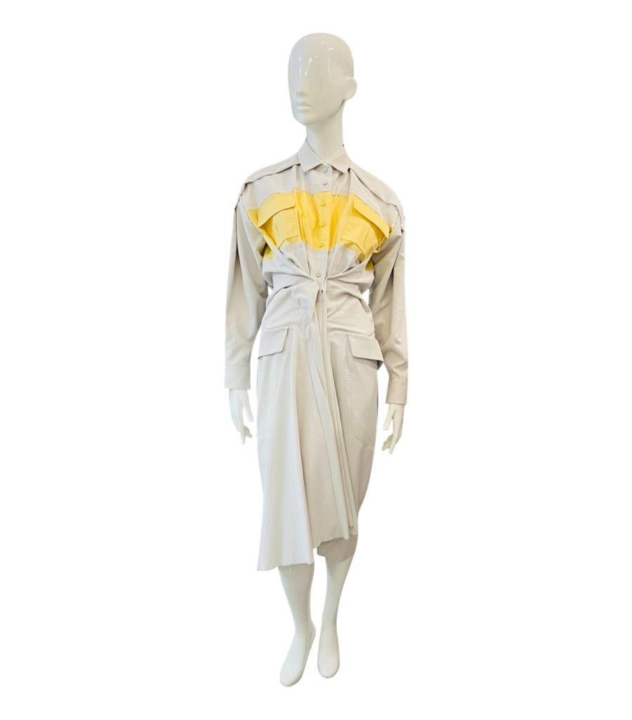 Carven Gathered Shirt Dress

Light grey knee-length dress with contrast yellow detail to the top with flap chest pockets.

Styled with gathered waist, raw edge detailing and silver 'C'' charm chain to back.

Featuring long sleeves, classic collar