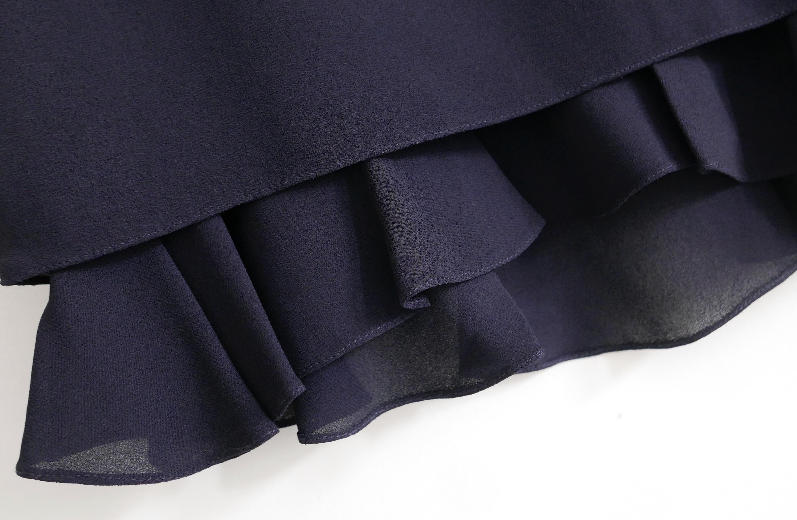 Super cute Carven navy crepe frill hem mini skirt.  New with tag/spar button. Made from navy viscose crepe with acetate and silk mix, chiffon frill hem petticoat lining. Has grosgrian lined waist and side zip with internal etched silvertone button.