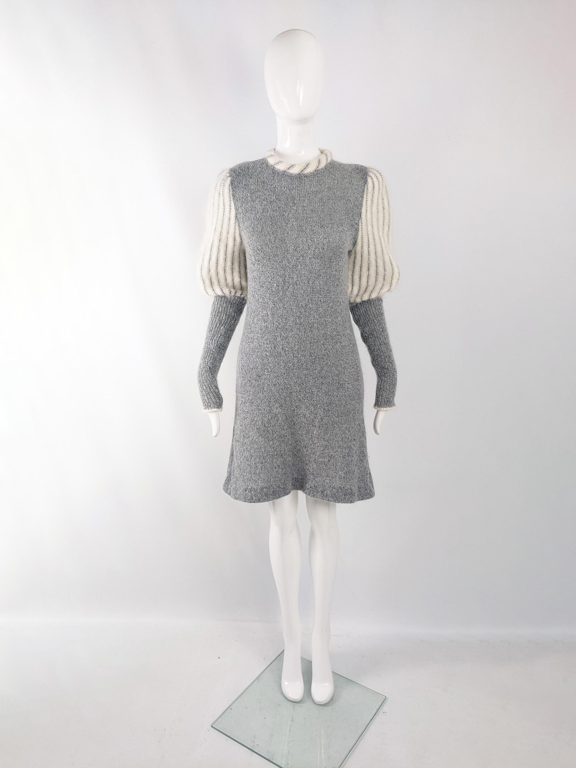 An incredible vintage womens knit dress from the late 70s / early 80s by luxury French fashion house, Carven. In a grey wool knit fabric with long sleeves and a fluffy cream mohair puffed design, giving a historical nod. It has a padded neckline, a