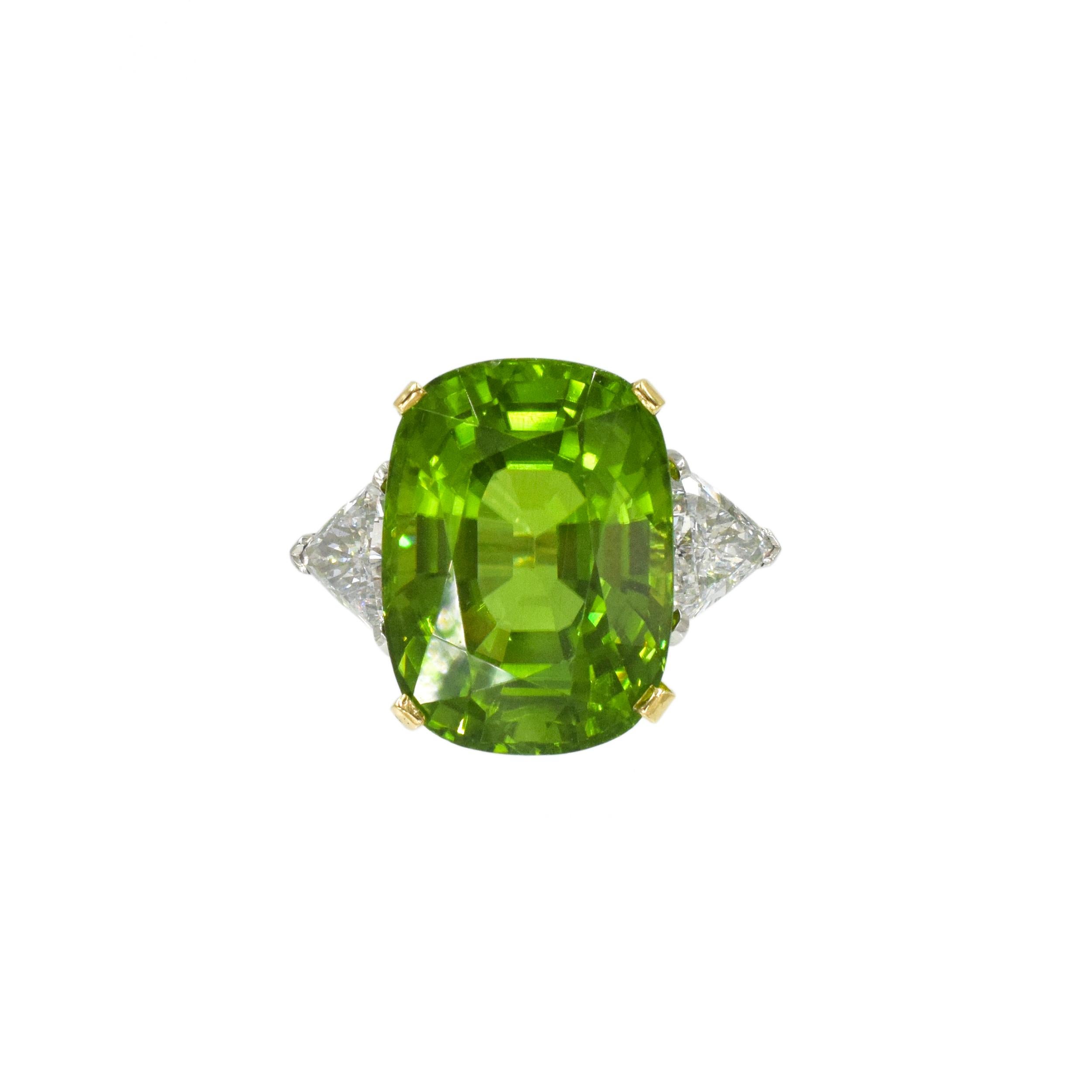 Carvin French Platinum and 18K Yellow Gold, Peridot and Diamond Ring, centered with 24.35 carats
cushion-shaped peridot, accented with 2 trillion-cut diamonds ap. 2.00 carats  Carvin French
obscured. Size 7 ½. Peridot: bright medium deep limey