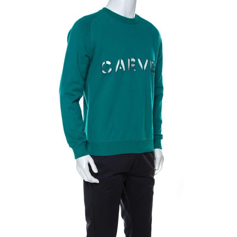 This well-tailored sweatshirt from the house of Carven sports finely crafted cotton body and logo cutout on the front. This creation in teal green tone gives a sharp look and lends a fine fit.