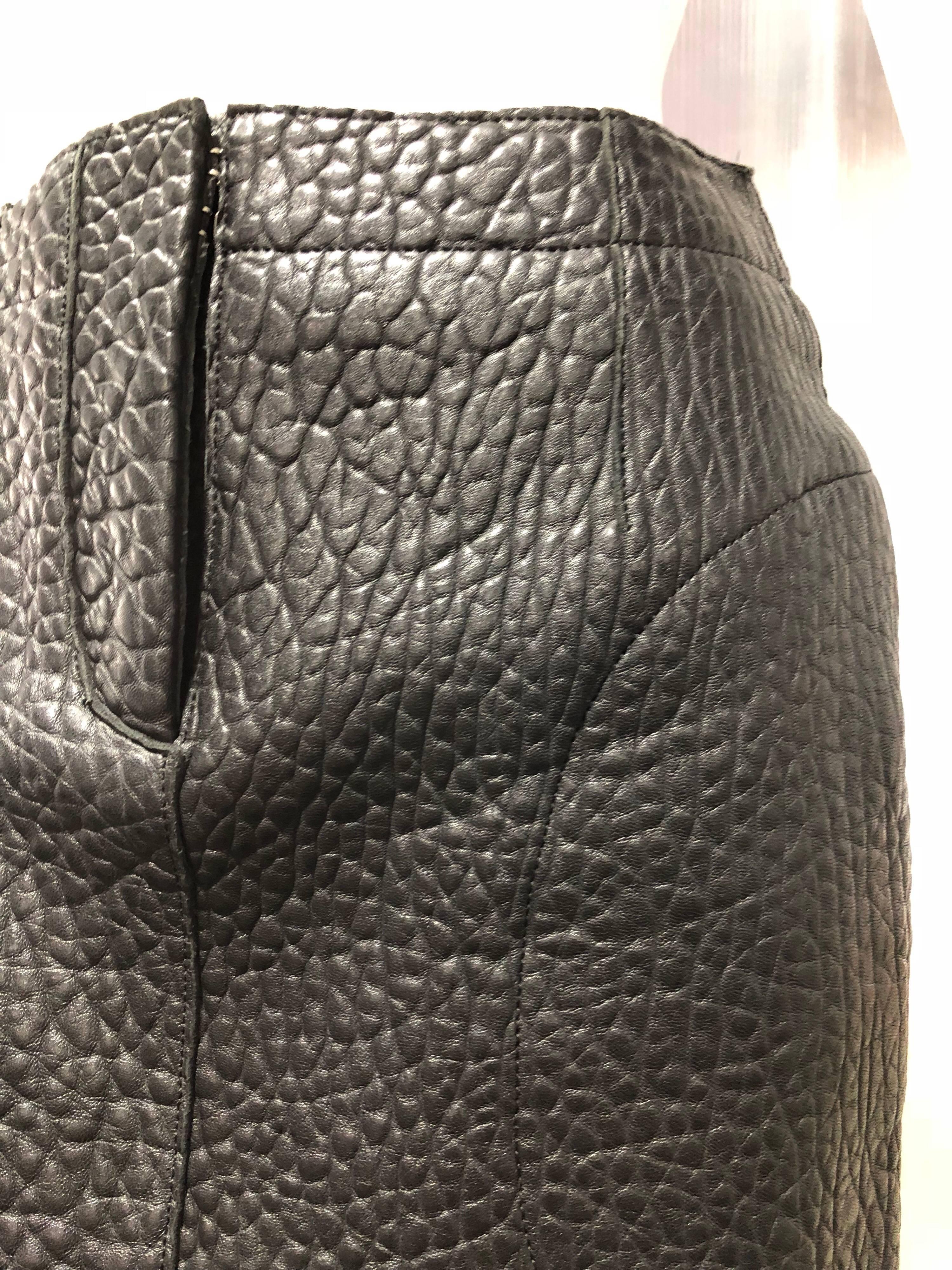 Carven embossed black leather skirt: Textured to resemble exotic skins. Front fly zipper. Deep side pockets and scooped and curved hemline. 
Channel your inner rockstar style vibe!
Fully lined.
Size 36.